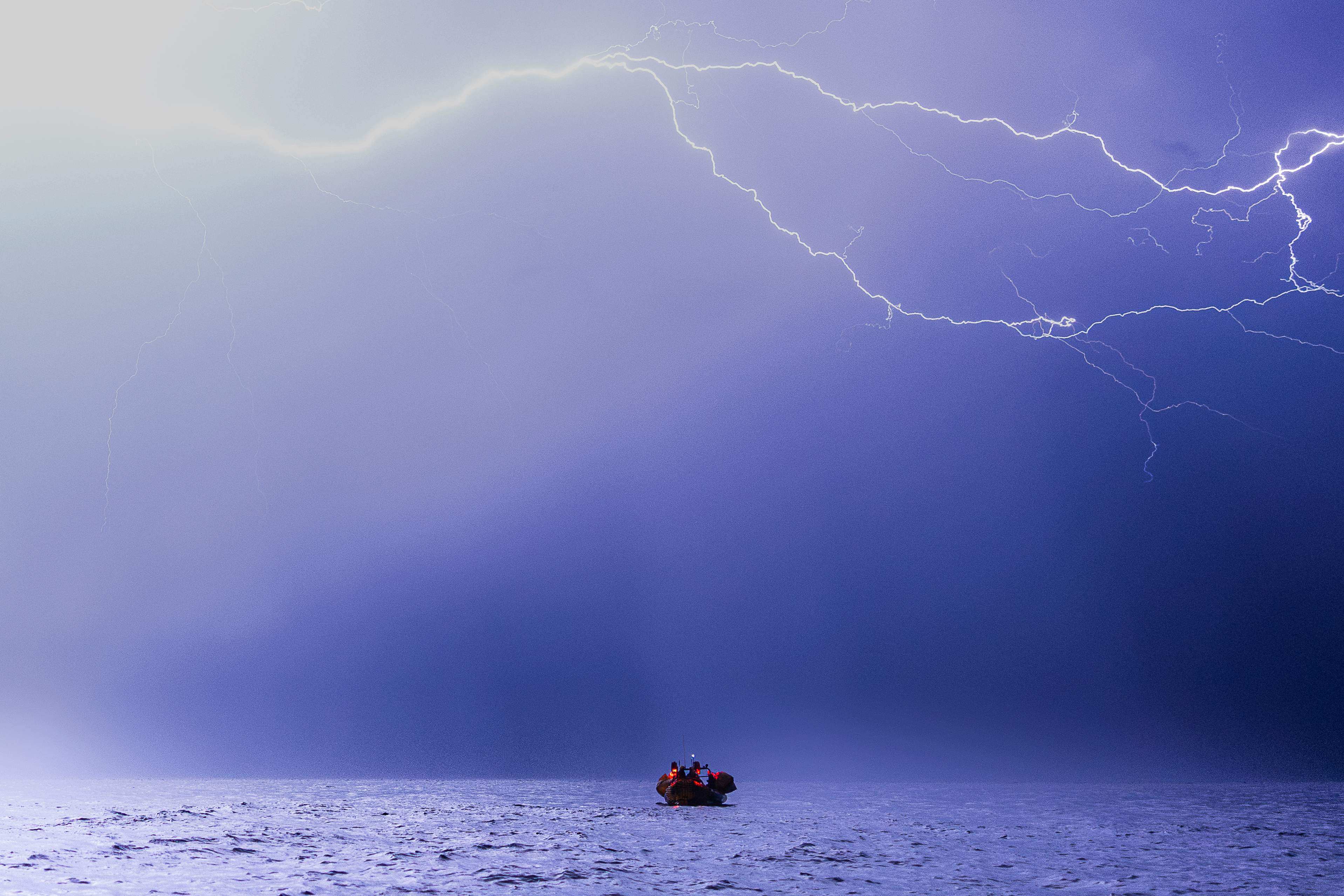 Crew members of the ‘Ocean Viking’ ship take part in a night rescue exercise in the Mediterranean Sea. Photo: AFP