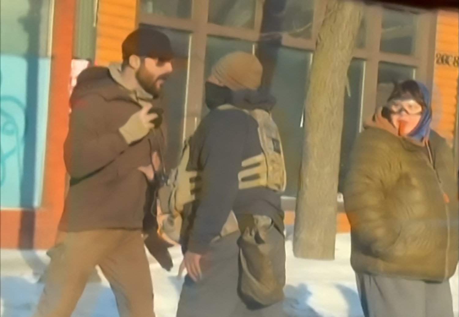 This screengrab of video footage shot by @dangjessie shows Alex Pretti (left) and a federal immigration agent (centre) before Pretti was shot dead in Minneapolis, Minnesota, on Saturday. Photo: @dangjessie/UGC/AFP