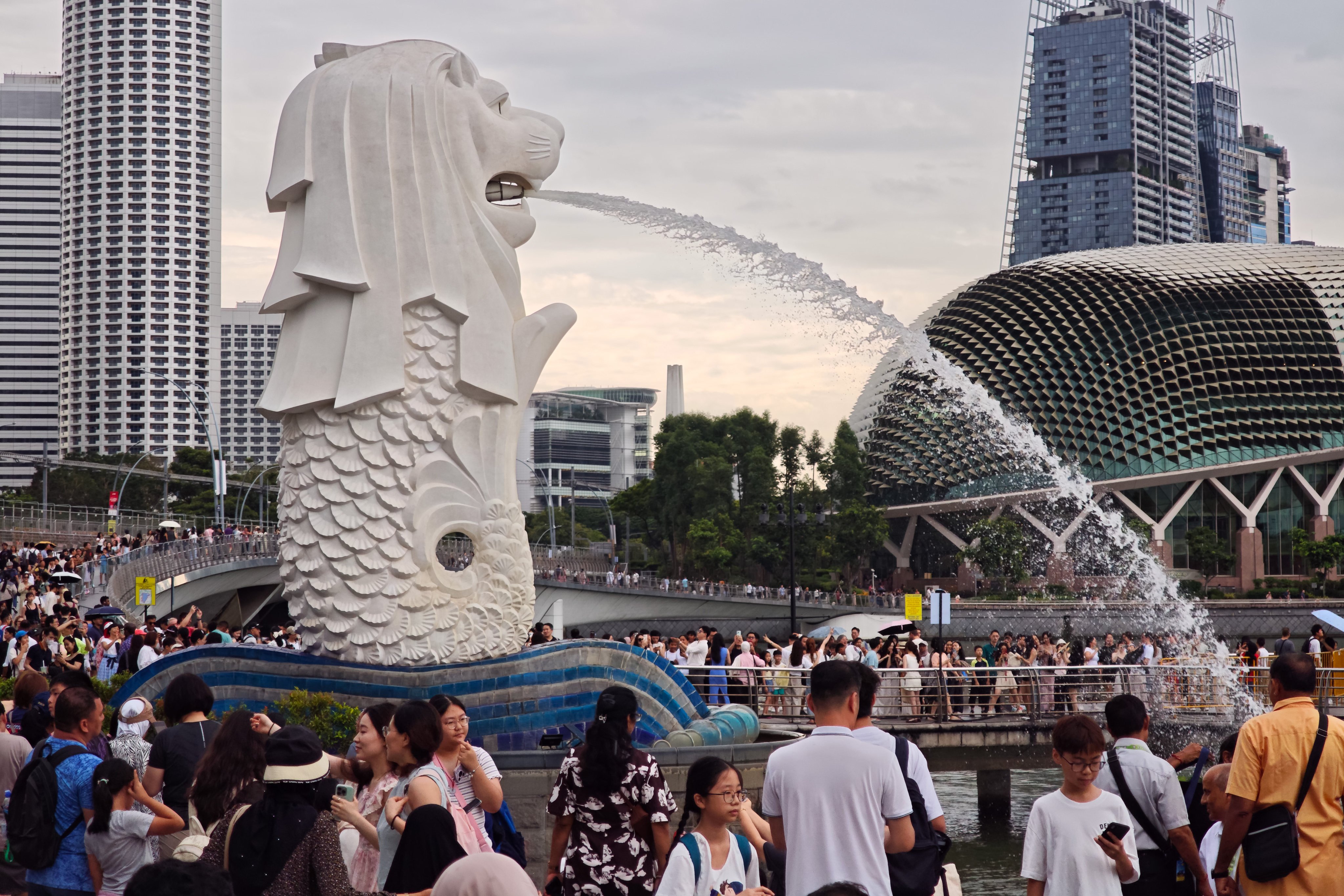 People gathering at the Merlion Park in Singapore. Photo: Wang Gang/Future Publishing via Getty Images