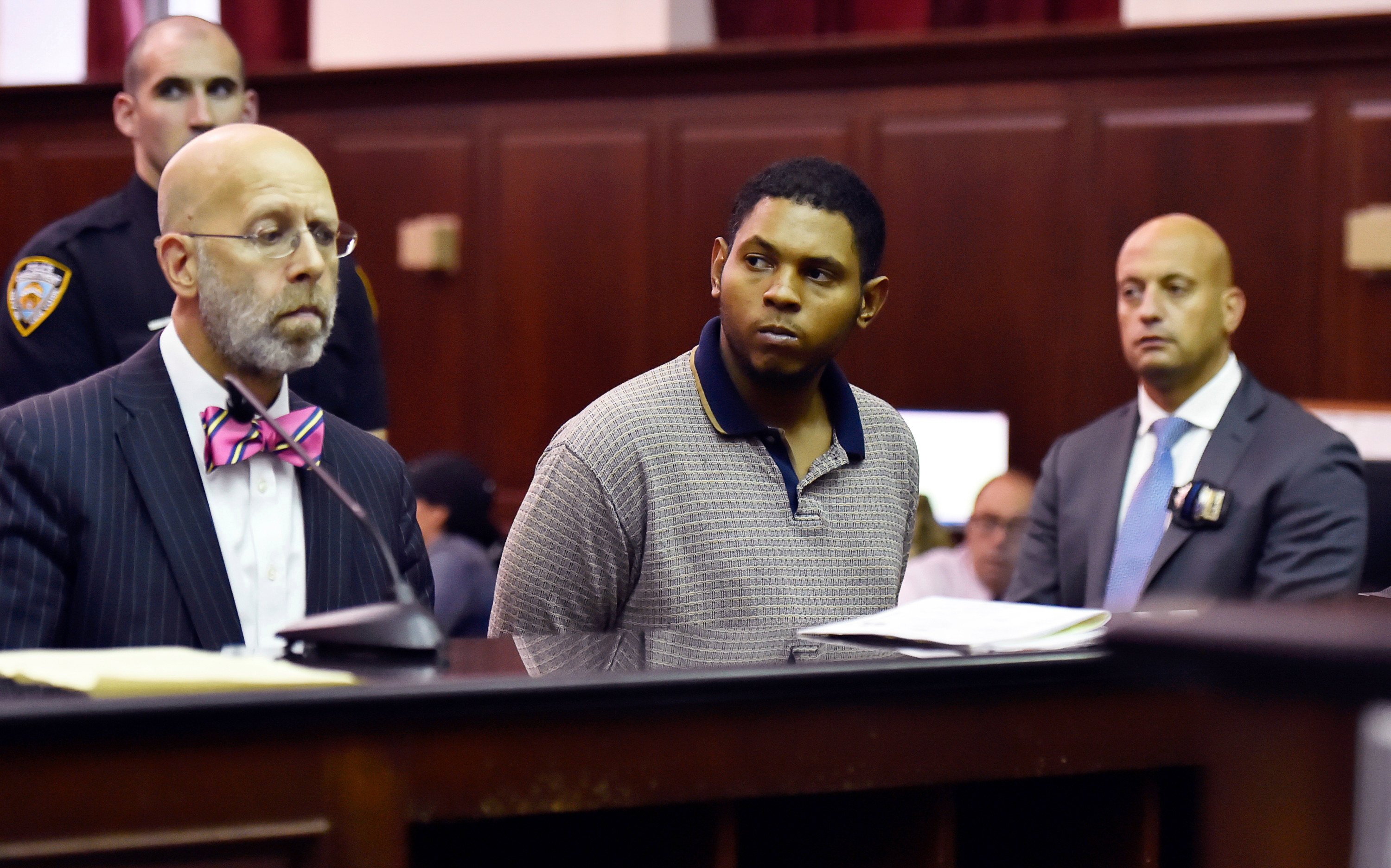 Randy Santos (centre) is arraigned in New York in October 2019 for the murder of four homeless men. Photo: New York Post via AP
