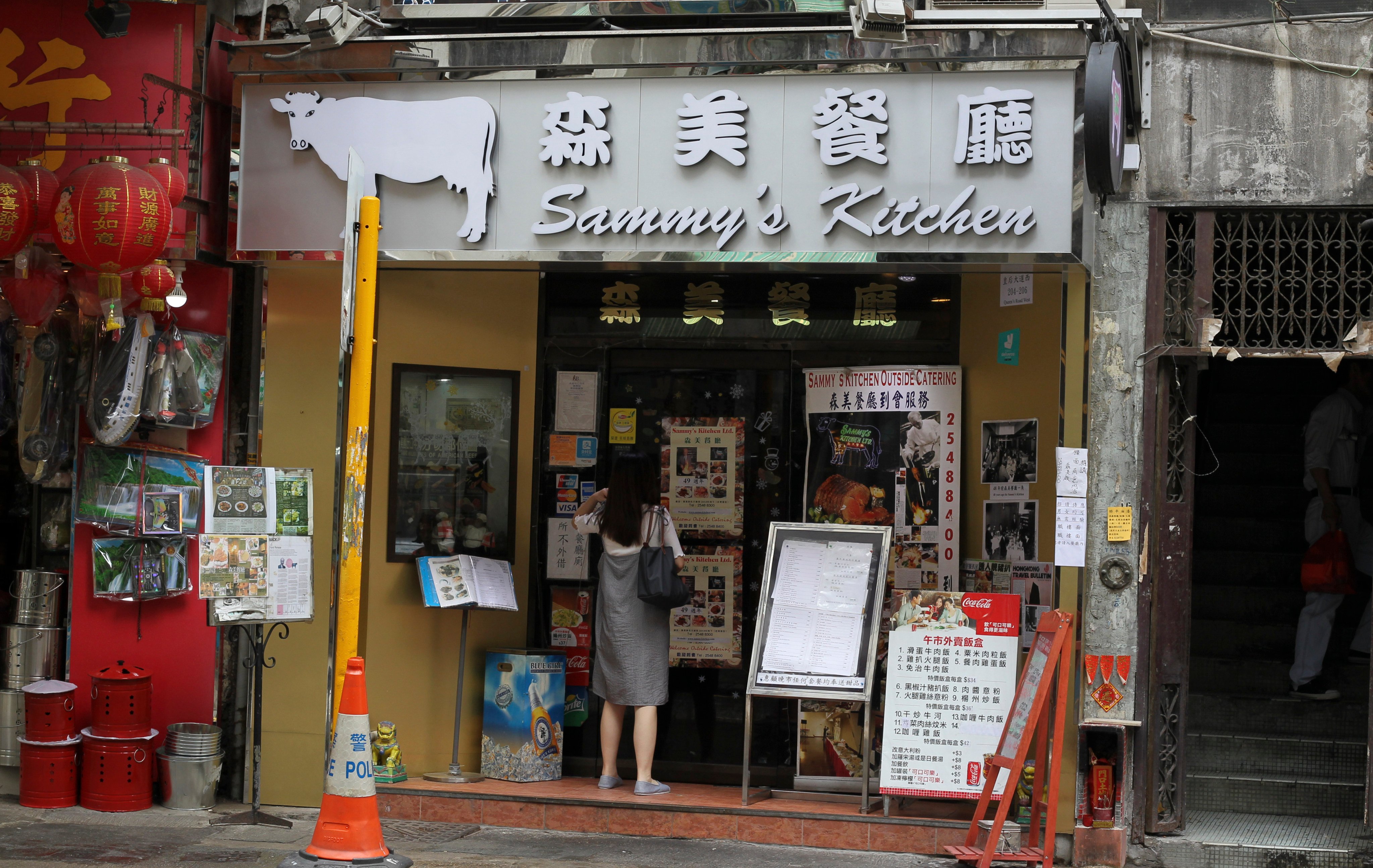 A customer stands outside Sammy’s Kitchen in Sai Ying Pun, Hong Kong, in June 2018. The restaurant has announced it will close - again - this time at the end of January 2026. Photo: Roy Issa