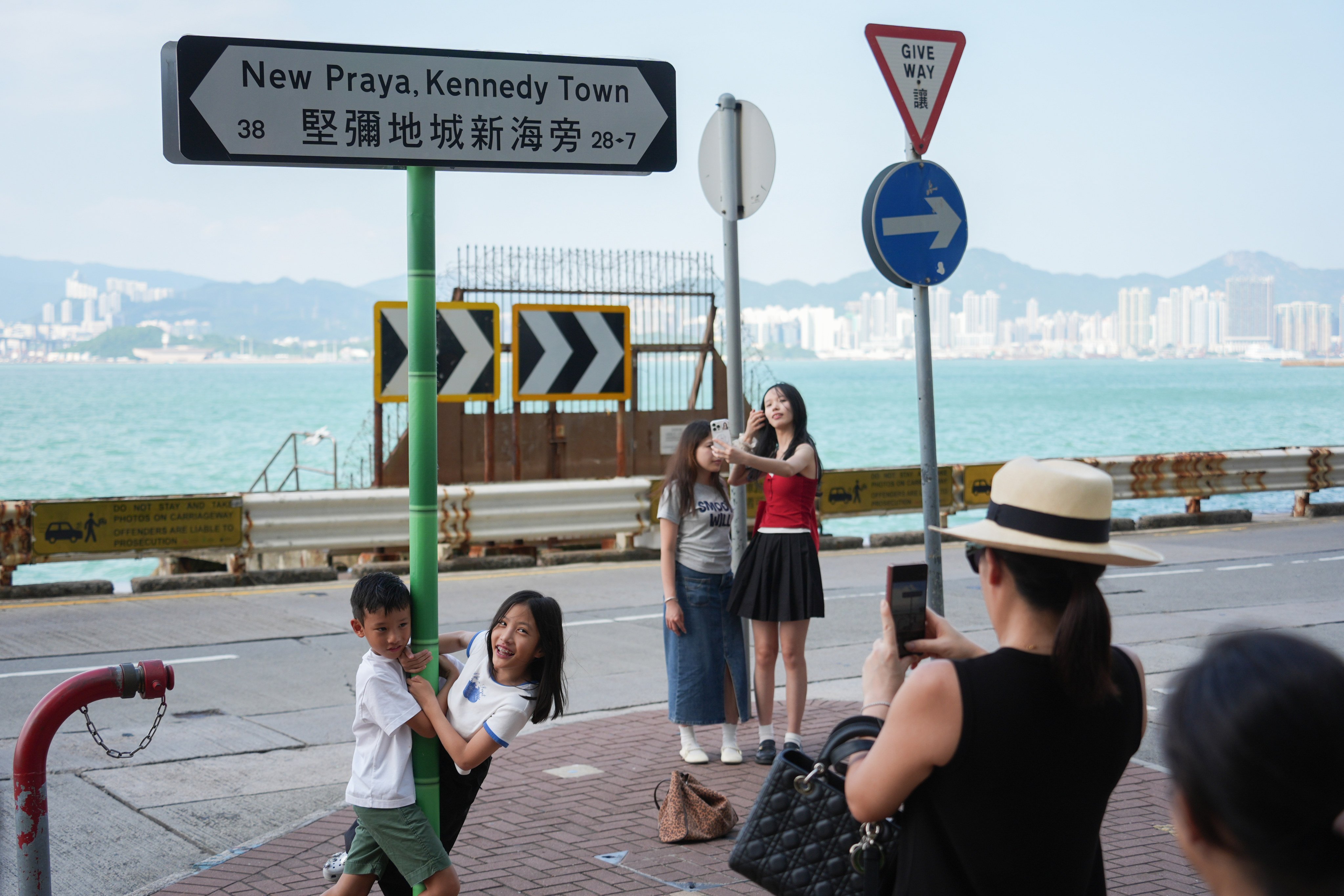 Mainland tourists take pictures in Kennedy Town. Photo: Eugene Lee