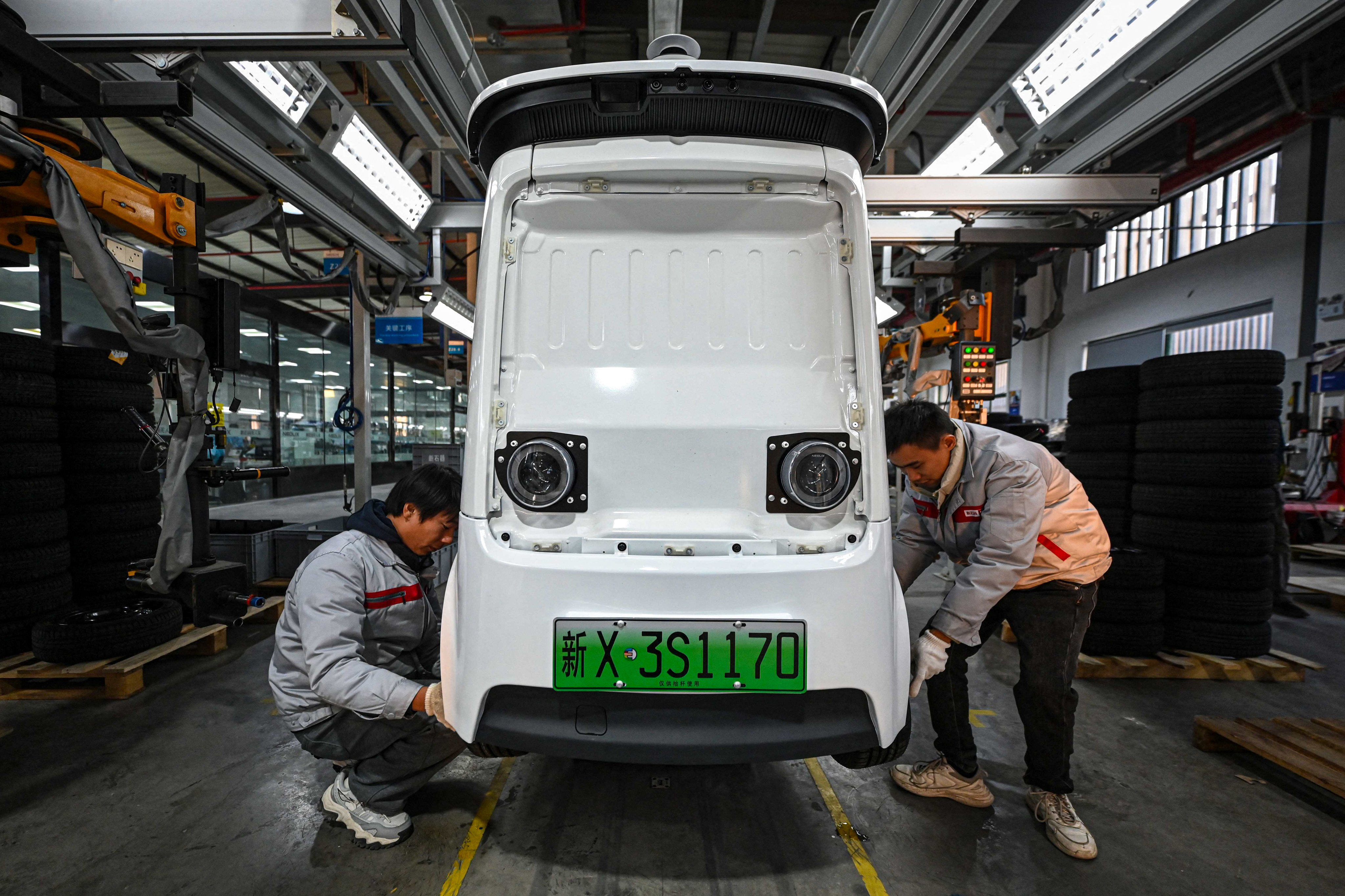 Employees work on a Neolix X3 vehicle production line at a factory of Chinese autonomous delivery vehicle maker Neolix in Yancheng, in eastern China’s Jiangsu province. Photo: AFP