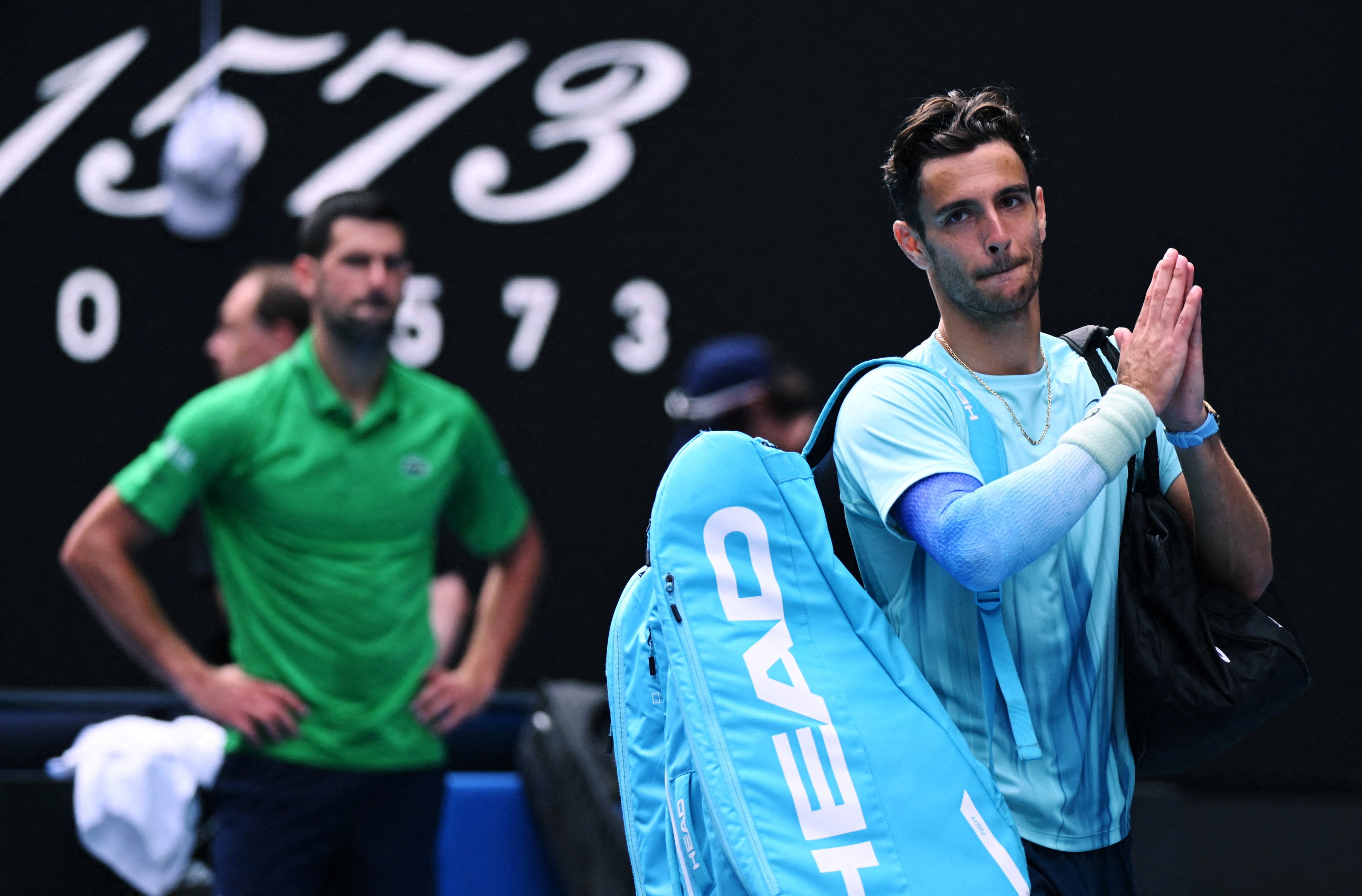 Italy’s Lorenzo Musetti applauds the fans as he walks off the court after retiring from his quarter-final match against Serbia’s Novak Djokovic on Wednesday. Photo: Reuters