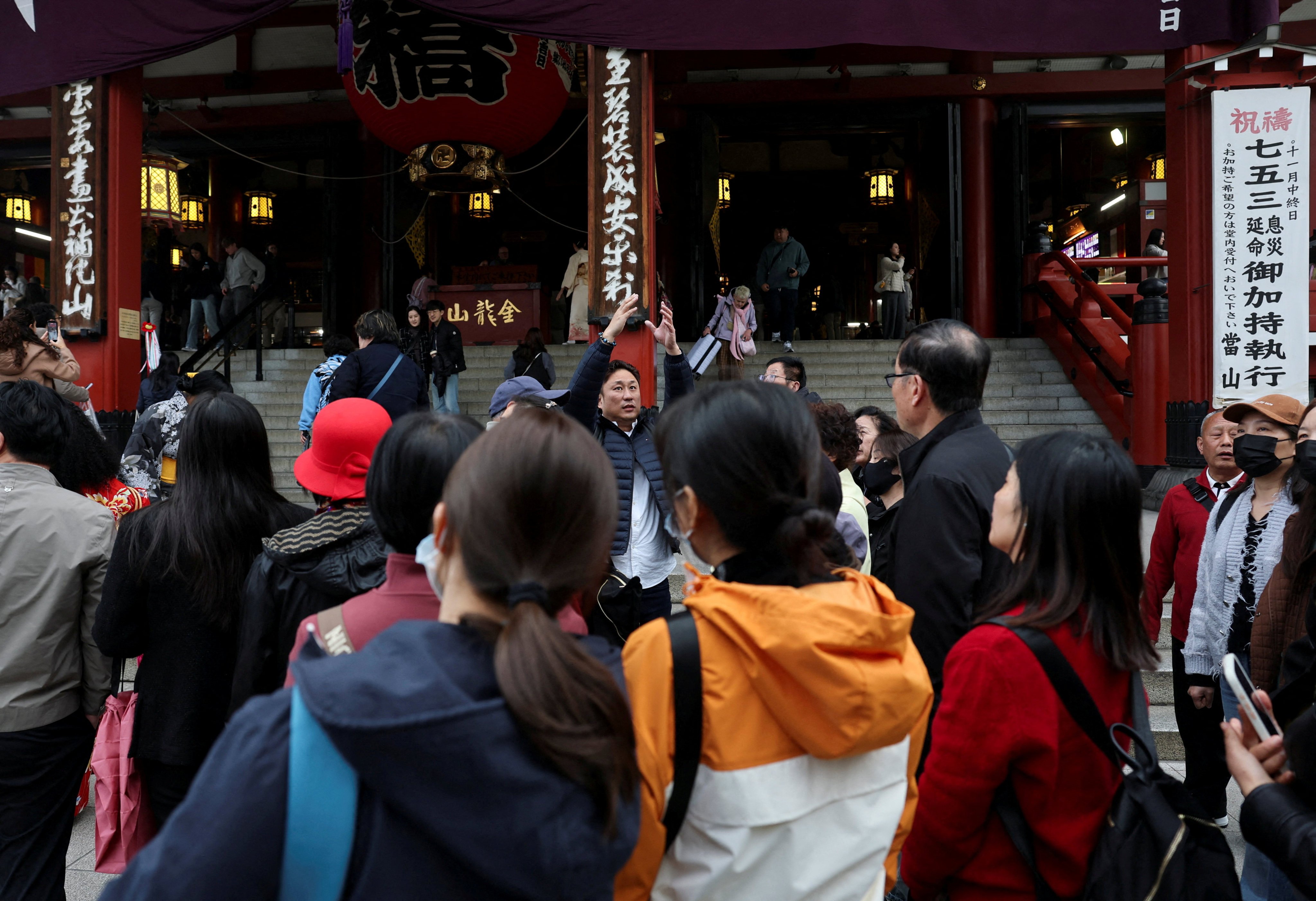A Chinese tourist group is led by a tour guide in Asakusa, a popular sightseeing spot in Tokyo, Japan, in November 2025. Photo: Reuters