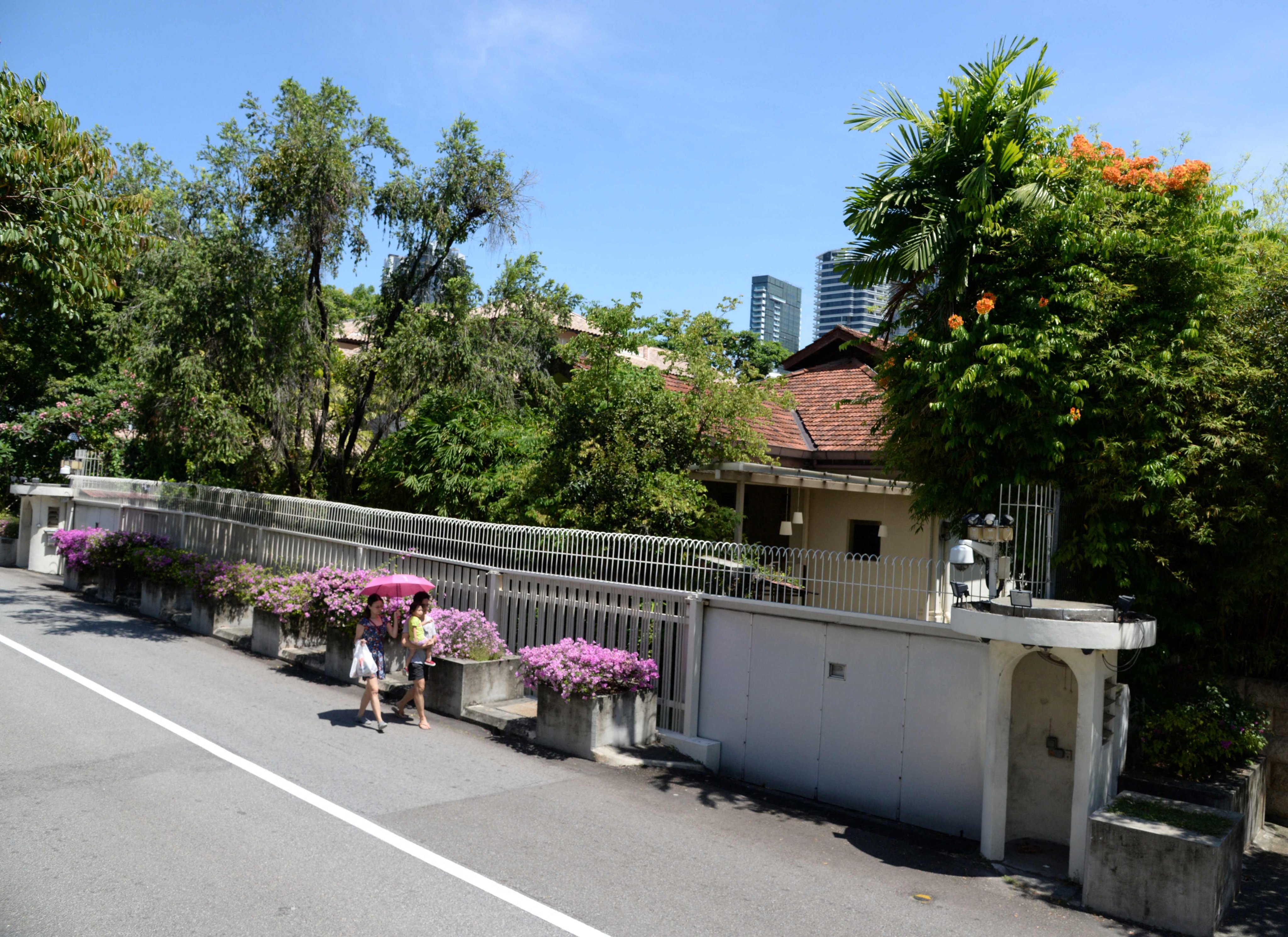 Residents walk past the house of Singapore’s founding prime minister Lee Kuan Yew at 38 Oxley Road in the city state. Photo: AFP