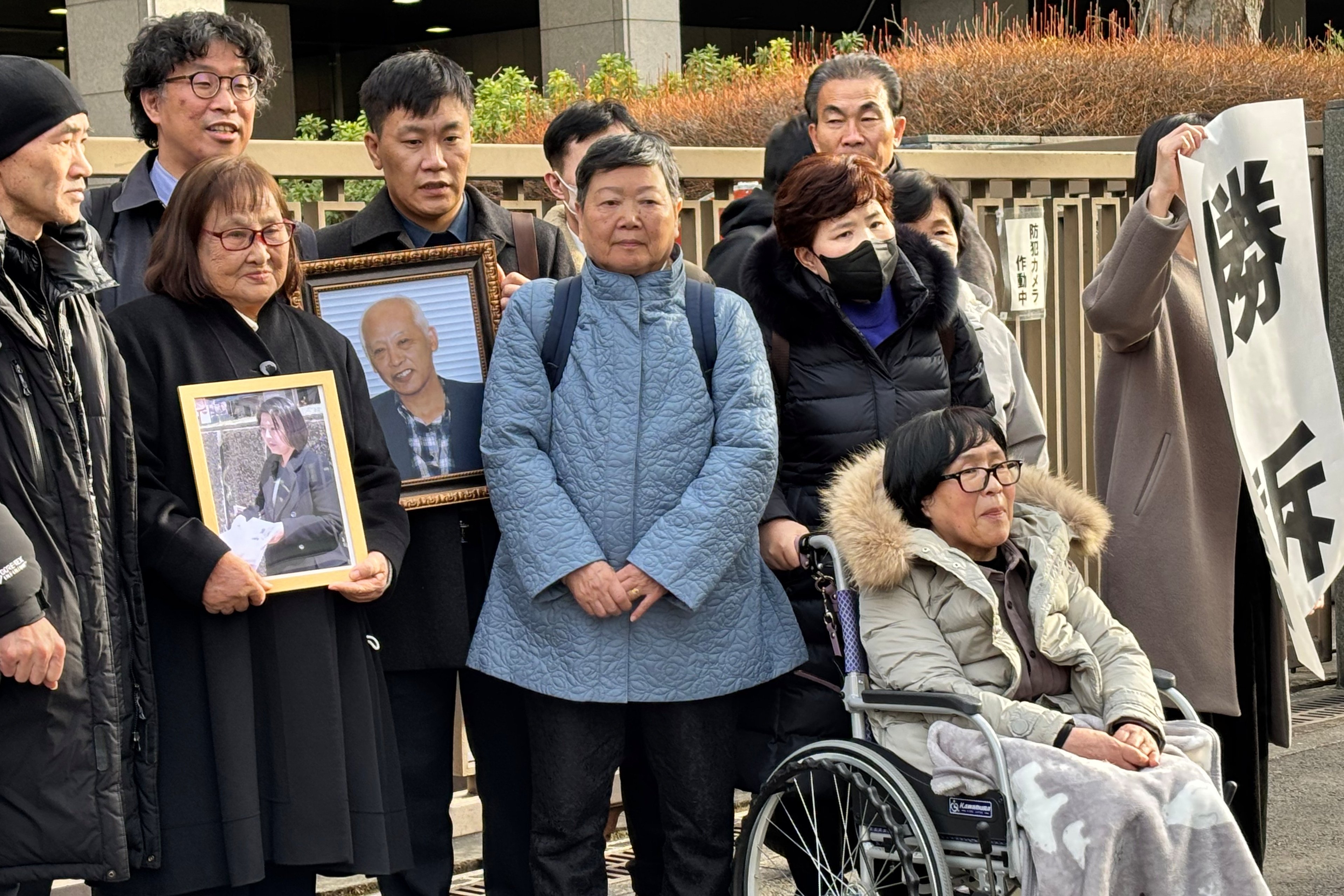 Plaintiffs, their lawyers and supporters gather outside the Tokyo District Court after winning its decision ordering North Korea to pay damages over its decades-long human rights violations after luring them to move to the North by Pyongyang’s false promises of living in “paradise on Earth”, on Monday in Japan. Photo: AP