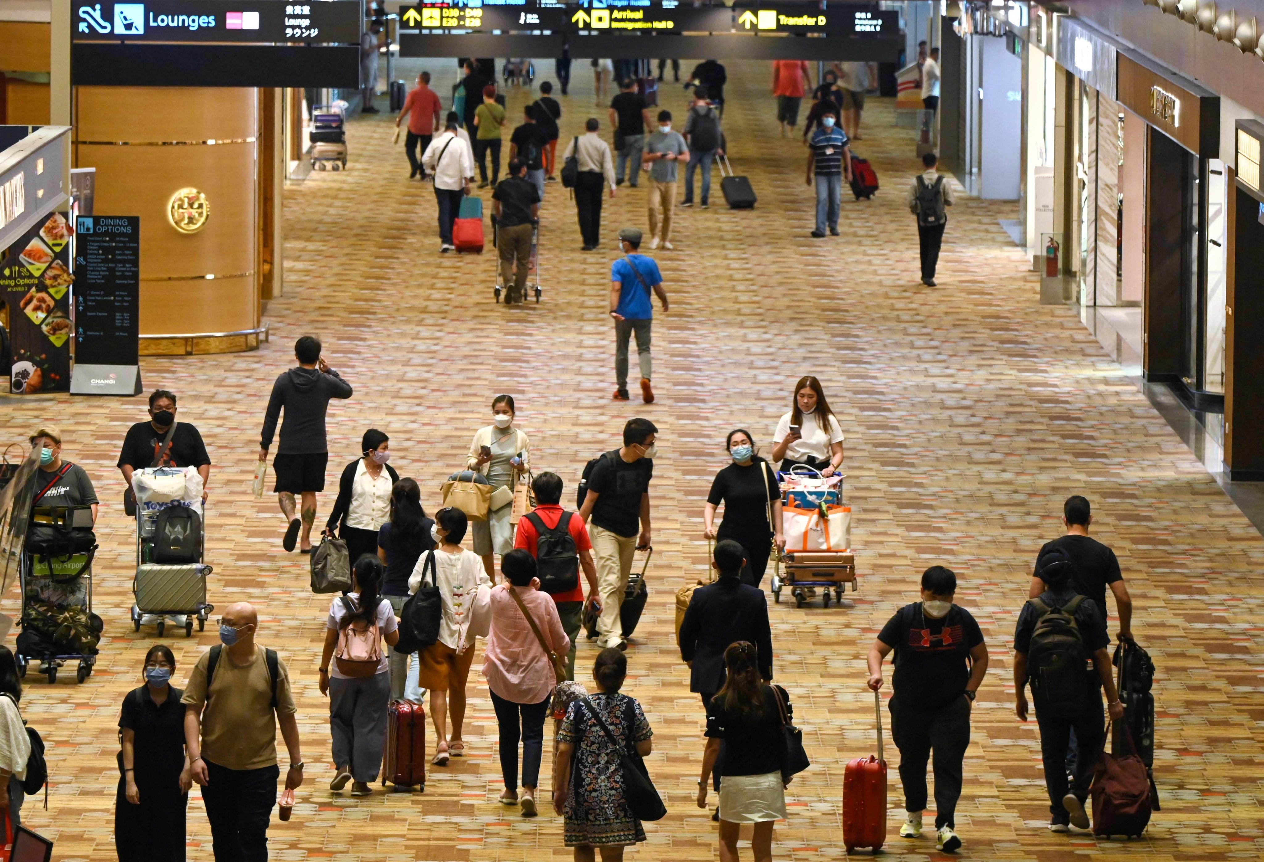 Travellers walk through a transit hall of Changi International Airport in Singapore. Photo: AFP