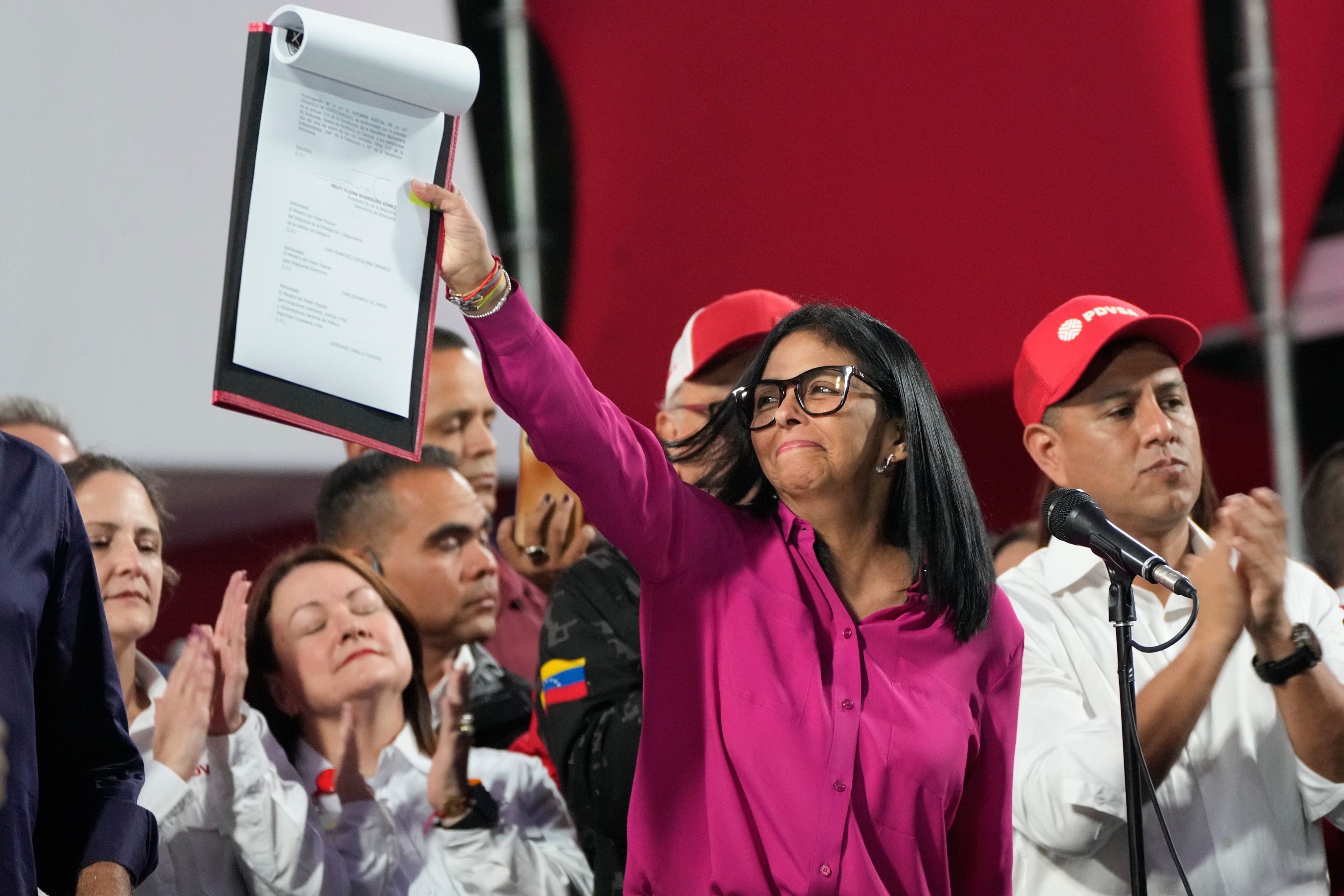Venezuela’s acting president Delcy Rodriguez holds up a copy of the new law. Photo: AP
