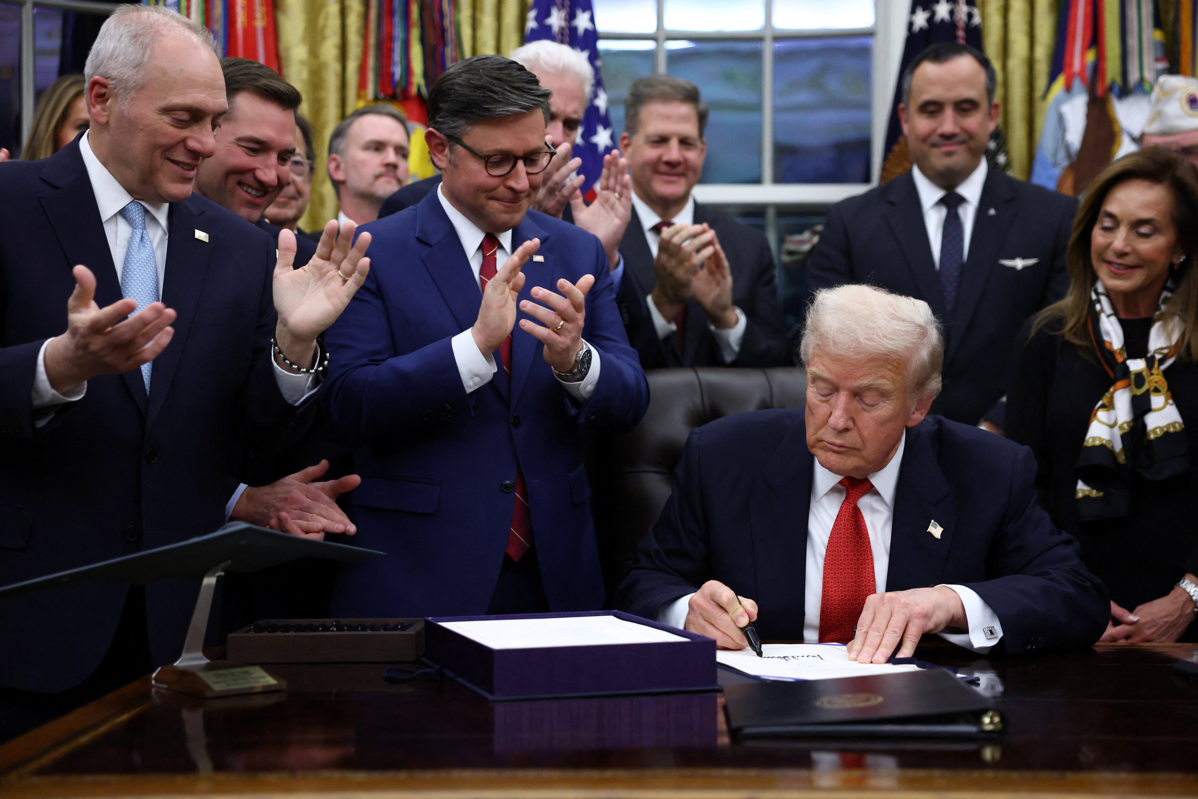 US President Donald Trump signs the funding bill to end the US government shutdown in November. Photo: Reuters