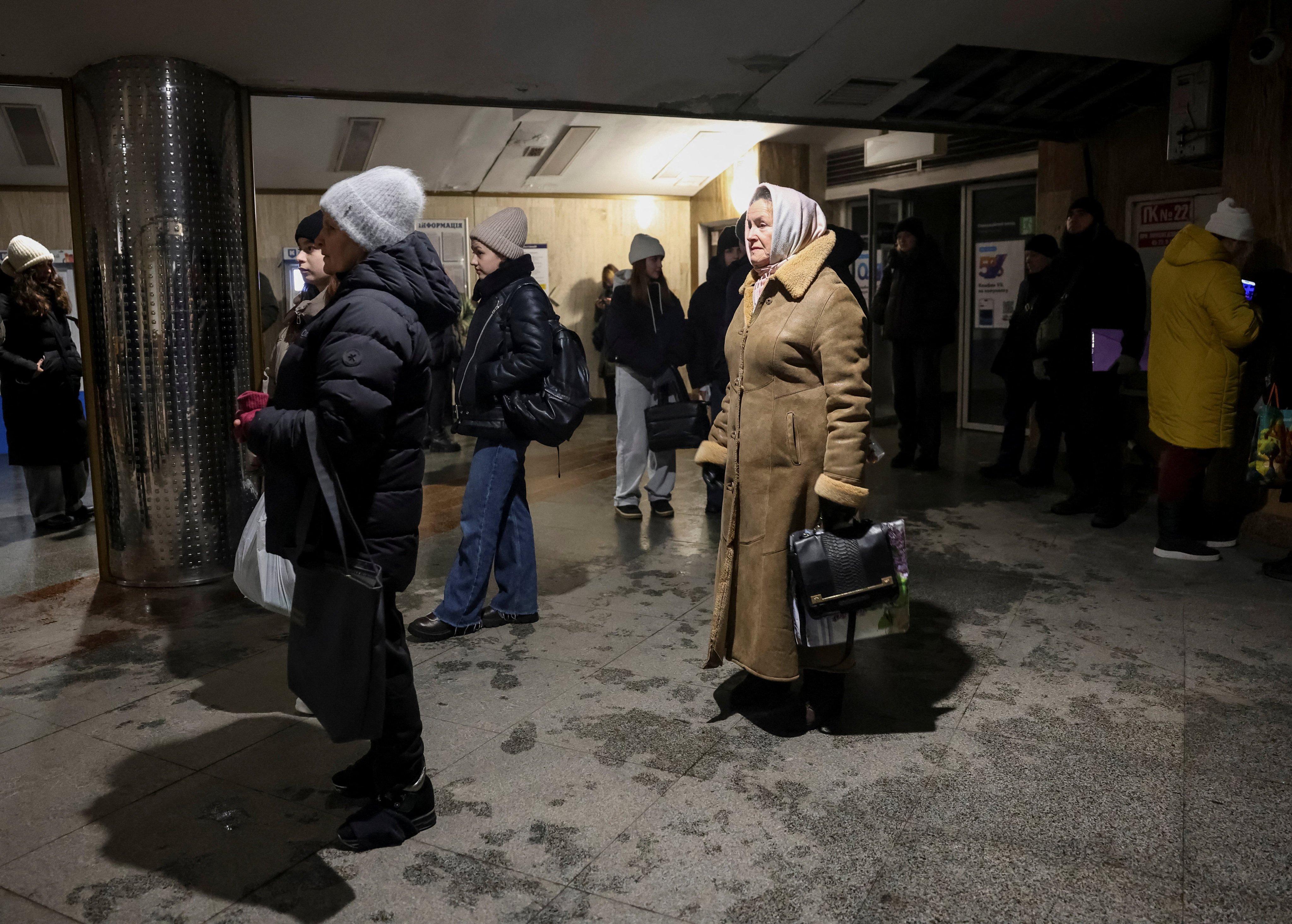 People in Kyiv stand at an entrance to a metro station while trains stopped running due to a blackout on Saturday. Photo: Reuters