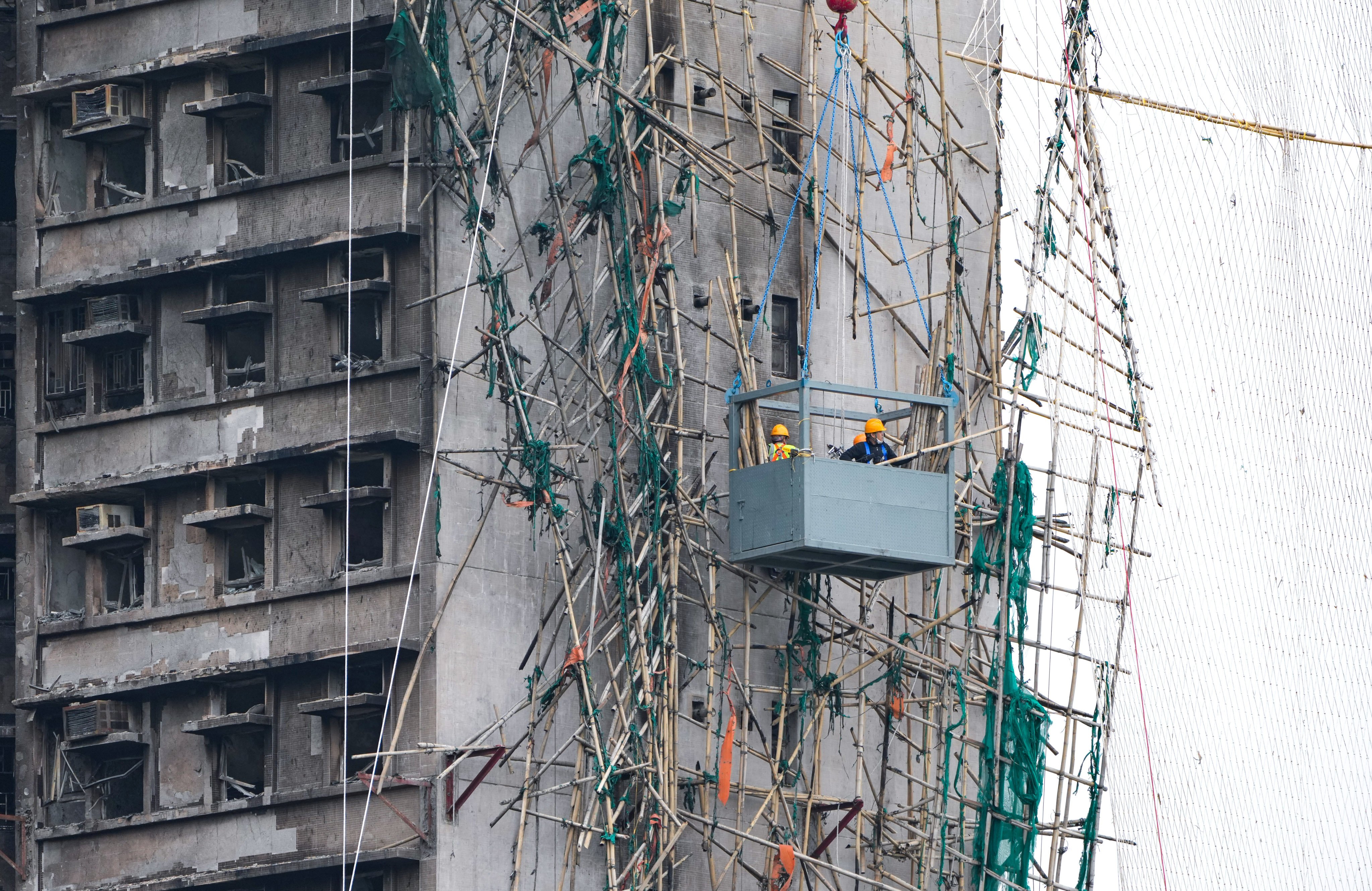Workers remove the damaged bamboo scaffolding in Wang Fuk Court at Tai Po. Photo: SCMP / Sam Tsang