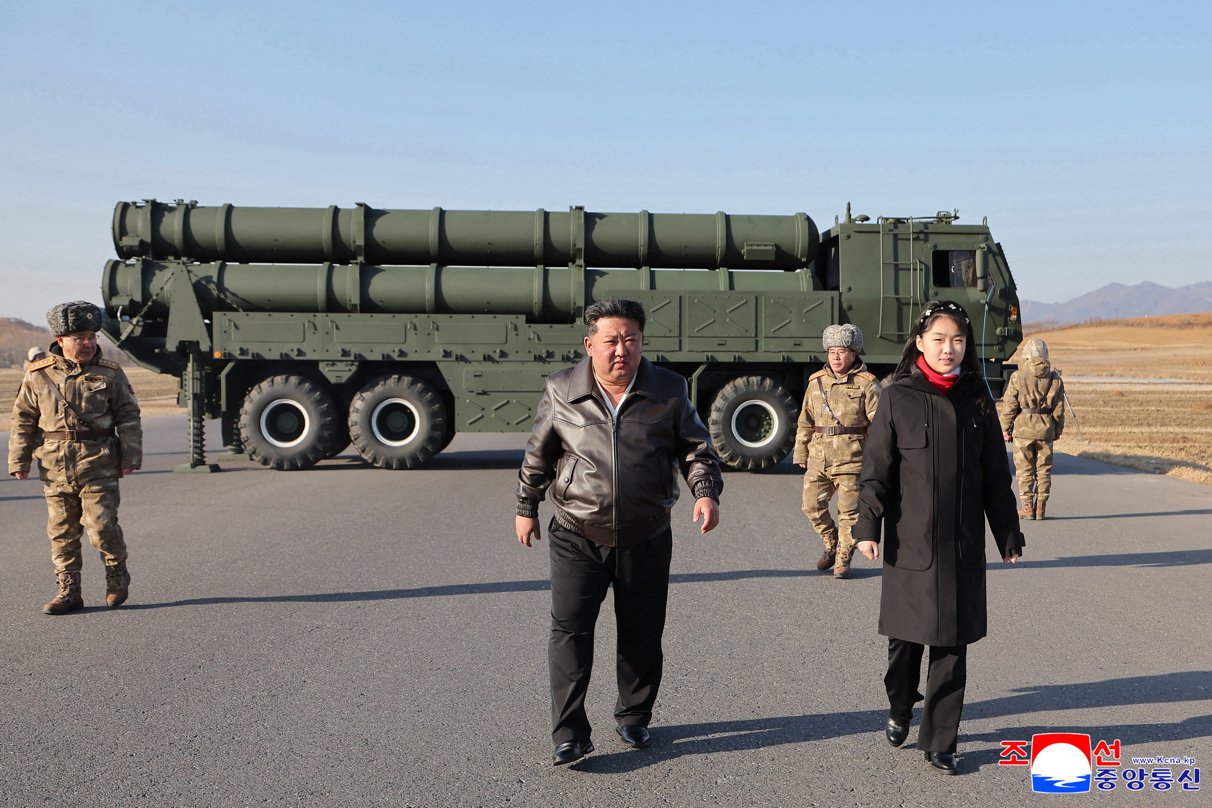 North Korean leader Kim Jong-un, accompanied by his daughter Kim Ju-ae, oversee a test-fire of a large-calibre multiple-rocket launcher system at an unknown location in North Korea. Photo: EPA/KCNA