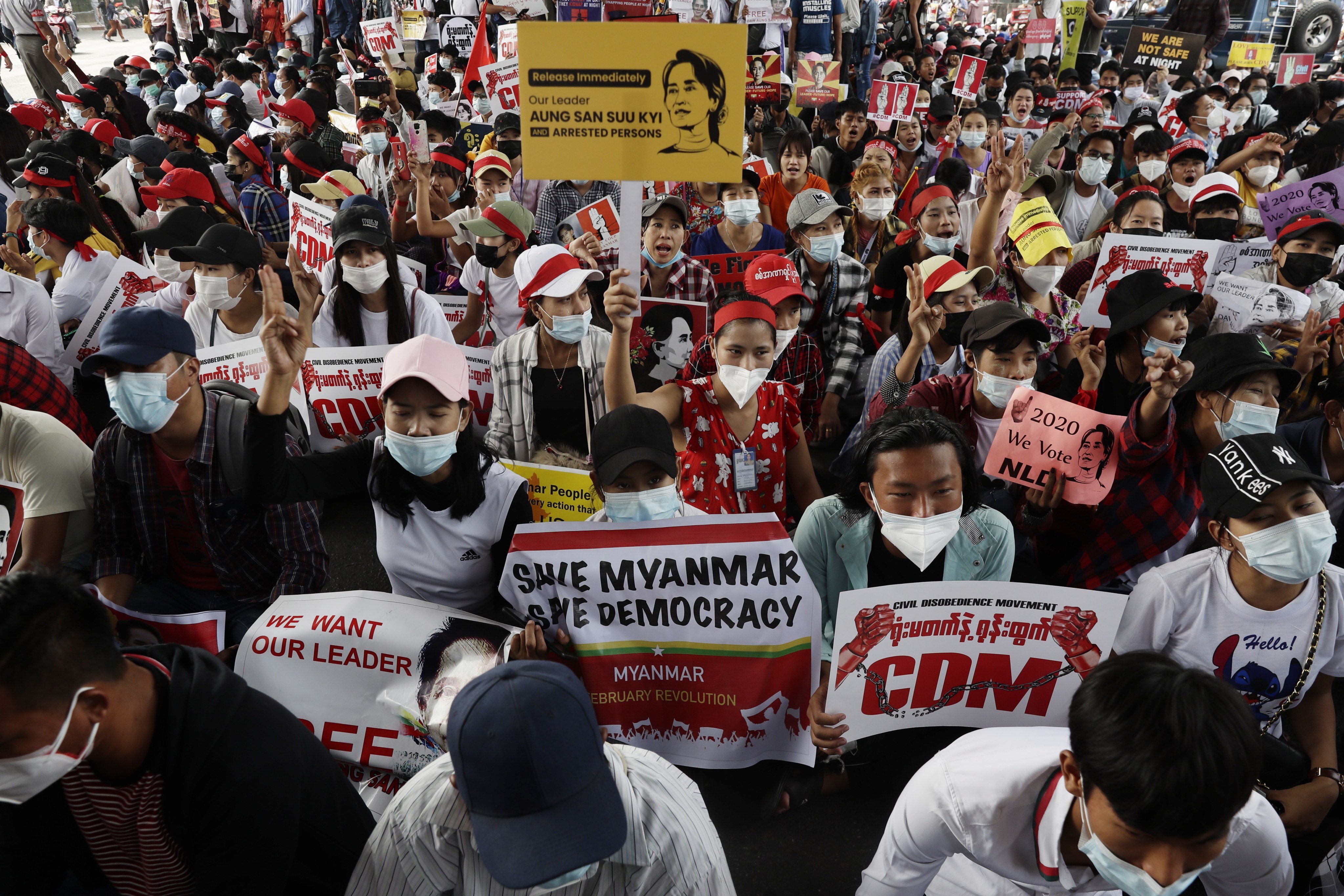 Demonstrators hold placards during a protest against the military coup in Yangon, Myanmar, on February 18, 2021. Photo: EPA-EFE