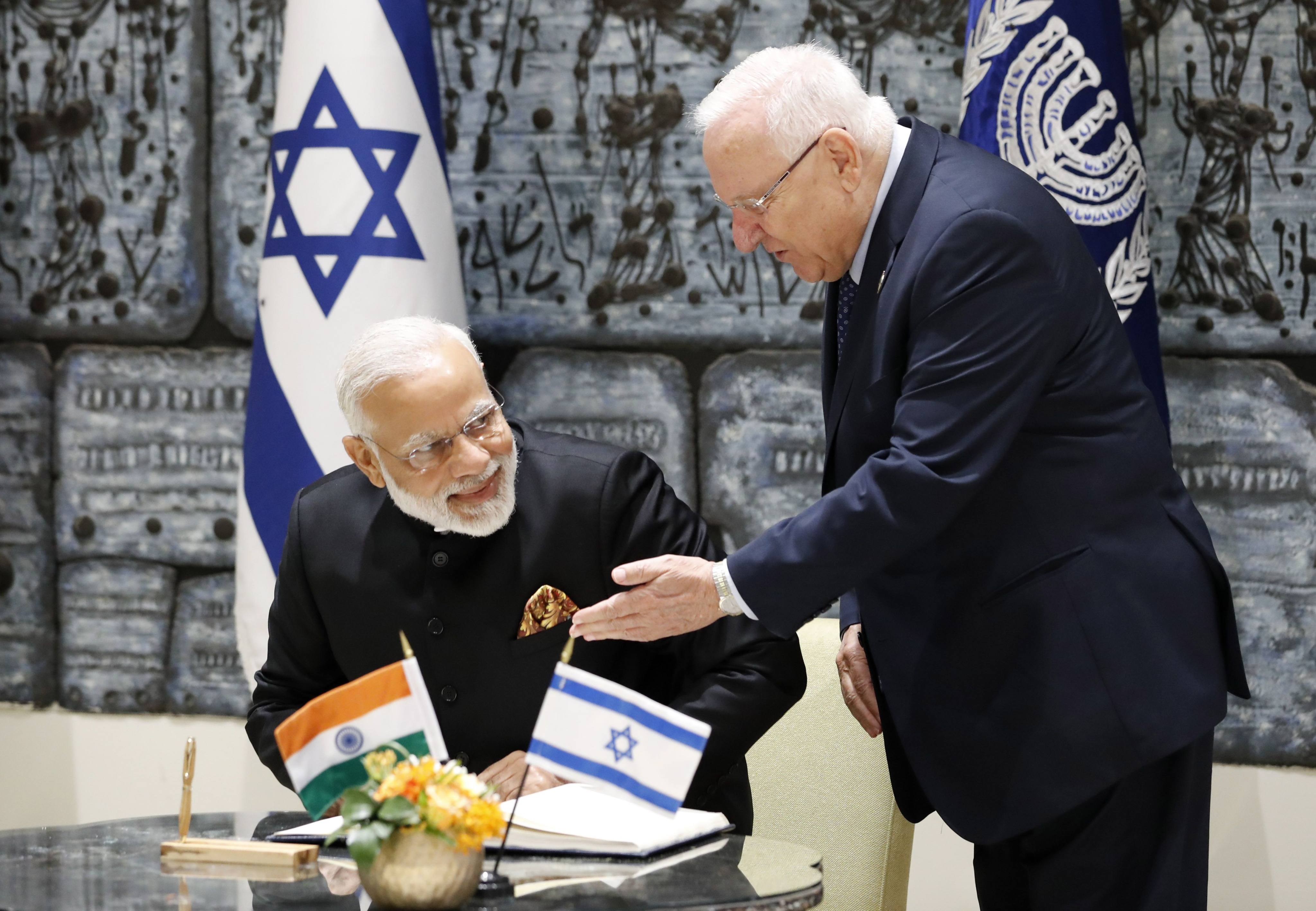 Israeli President Reuven Rivlin (right) gestures as Indian Prime Minister Narendra Modi sits to sign the guest book during a welcome ceremony in Jerusalem in 2017. Photo: AFP