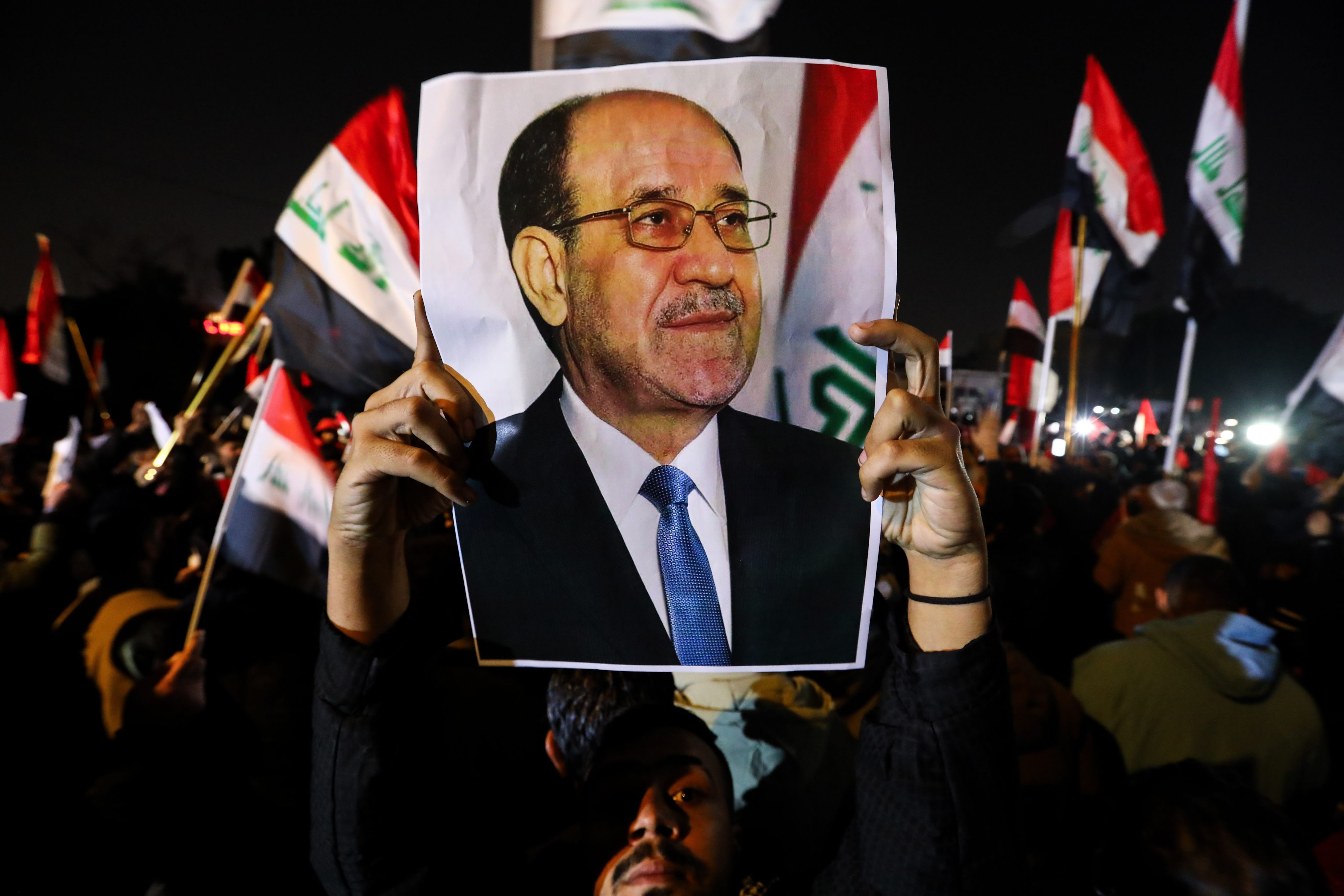 A protester holds a portrait of former Iraqi prime minister Nouri al-Maliki during a protest against US President Donald Trump near the US embassy in Baghdad, Iraq, on Thursday. Photo: dpa