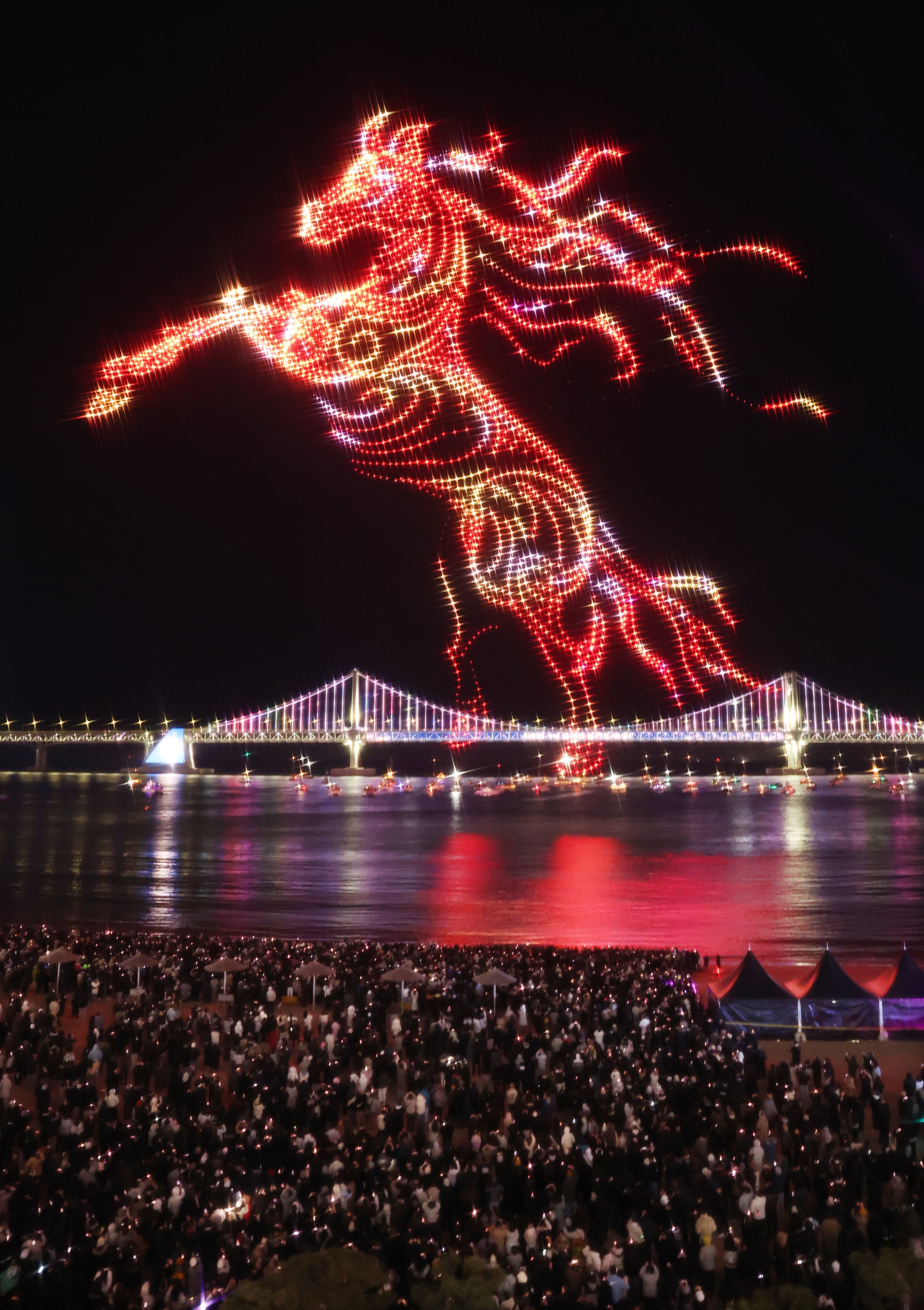 Drones are lit up to create an image of a red horse in Busan, South Korea. Photo: EPA