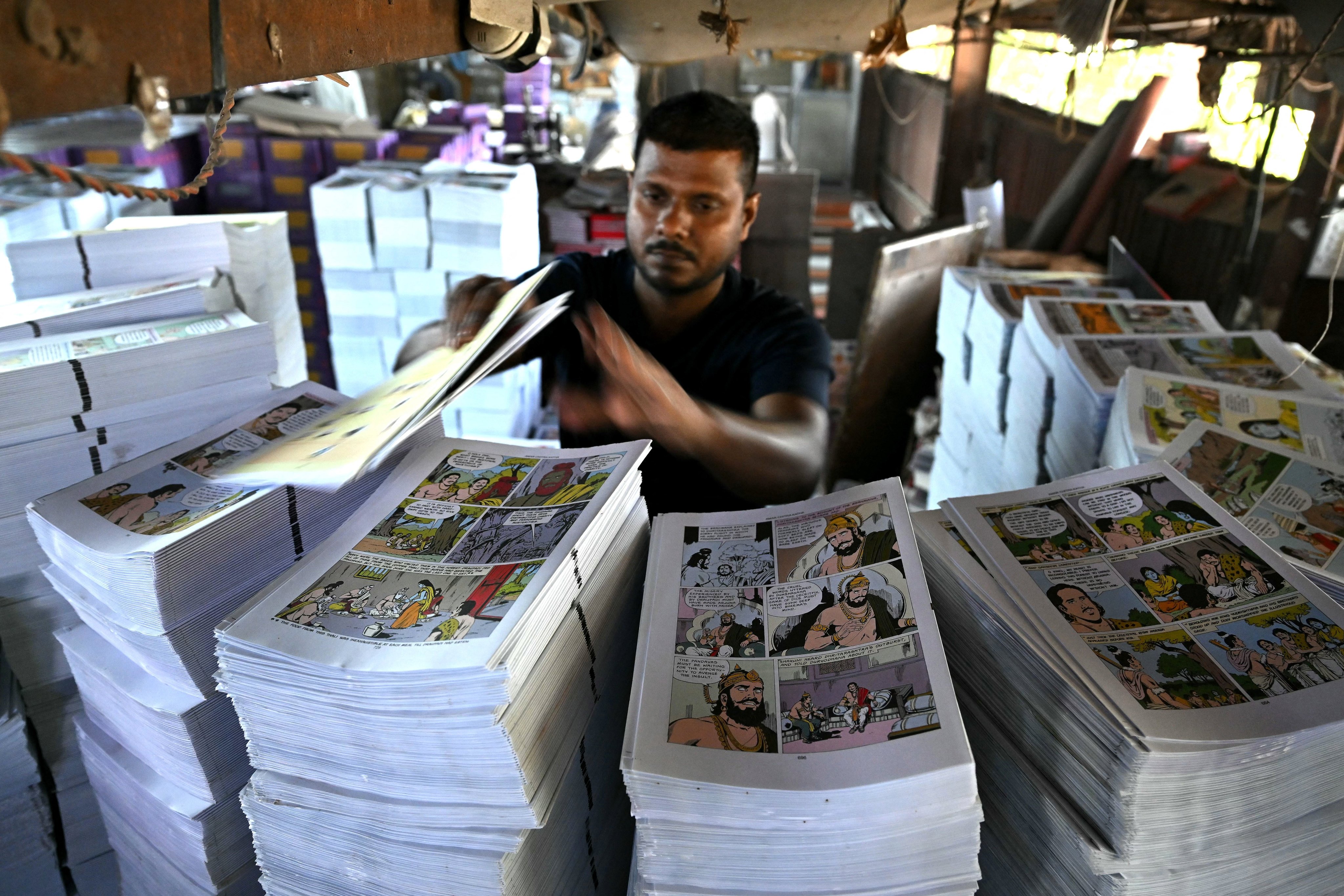 This photograph taken on January 16, 2026 shows a worker arranging pages for binding at Indias oldest and indigenous comic book publisher Amar Chitra Katha’s printing press in Mumbai. When India’s comic book series Amar Chitra Katha was launched in 1967, its mission was simple: introduce children to the country’s vast universe of Hindu gods, legends and history.
Nearly six decades later, the comic, known simply as ACK and meaning “immortal illustrated stories”, is still holding its ground in an era ruled by smartphones and streaming television. (Photo by Indranil MUKHERJEE / AFP)