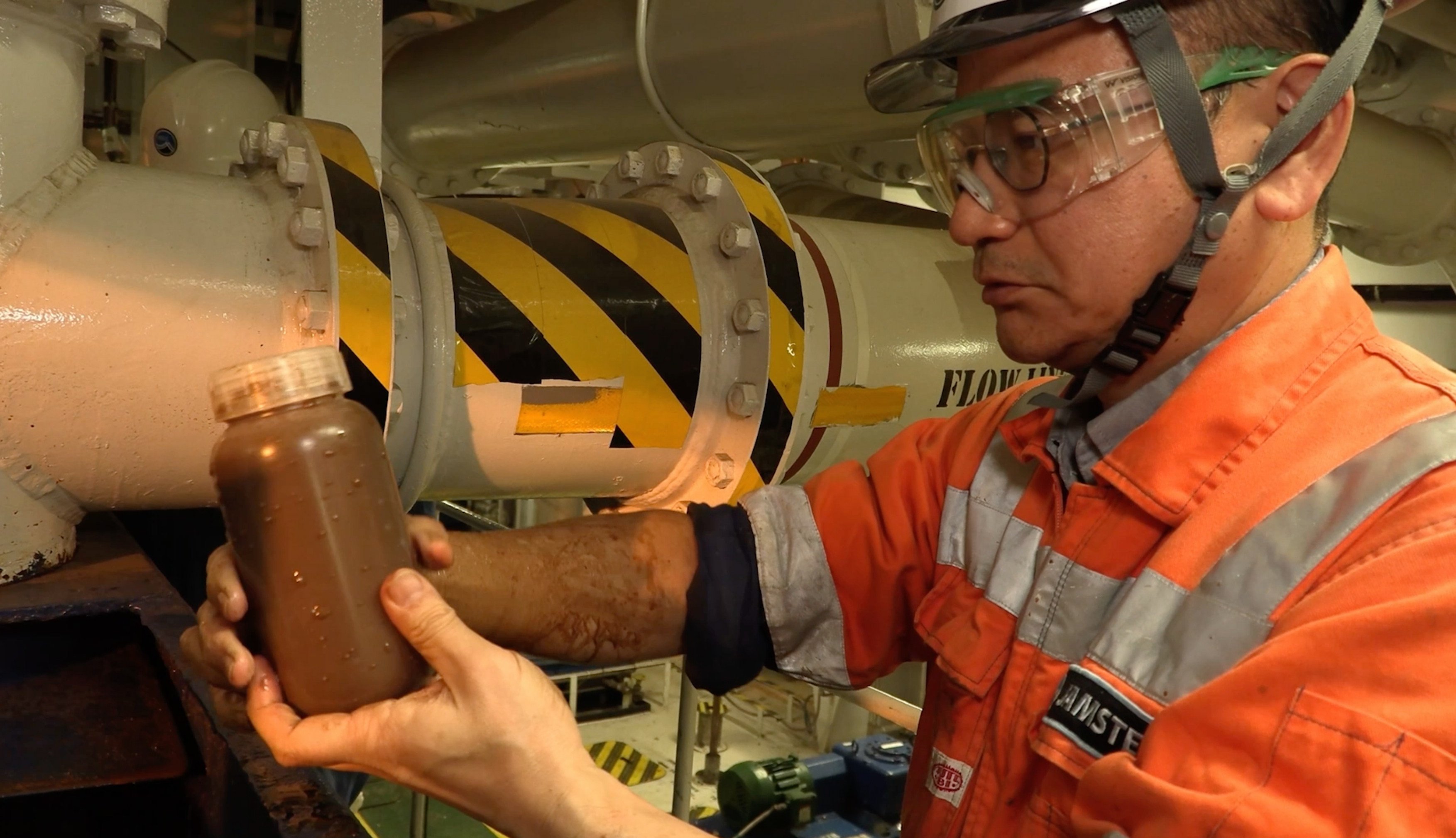 This photo provided by SIP/Japan Agency for Marine-Earth Science and Technology, shows rare earth–rich mud recovered aboard a vessel and placed into bottles off Minamitorishima, south of Tokyo, on Feb. 1, 2026. (SIP/Japan Agency for Marine-Earth Science and Technology via AP)