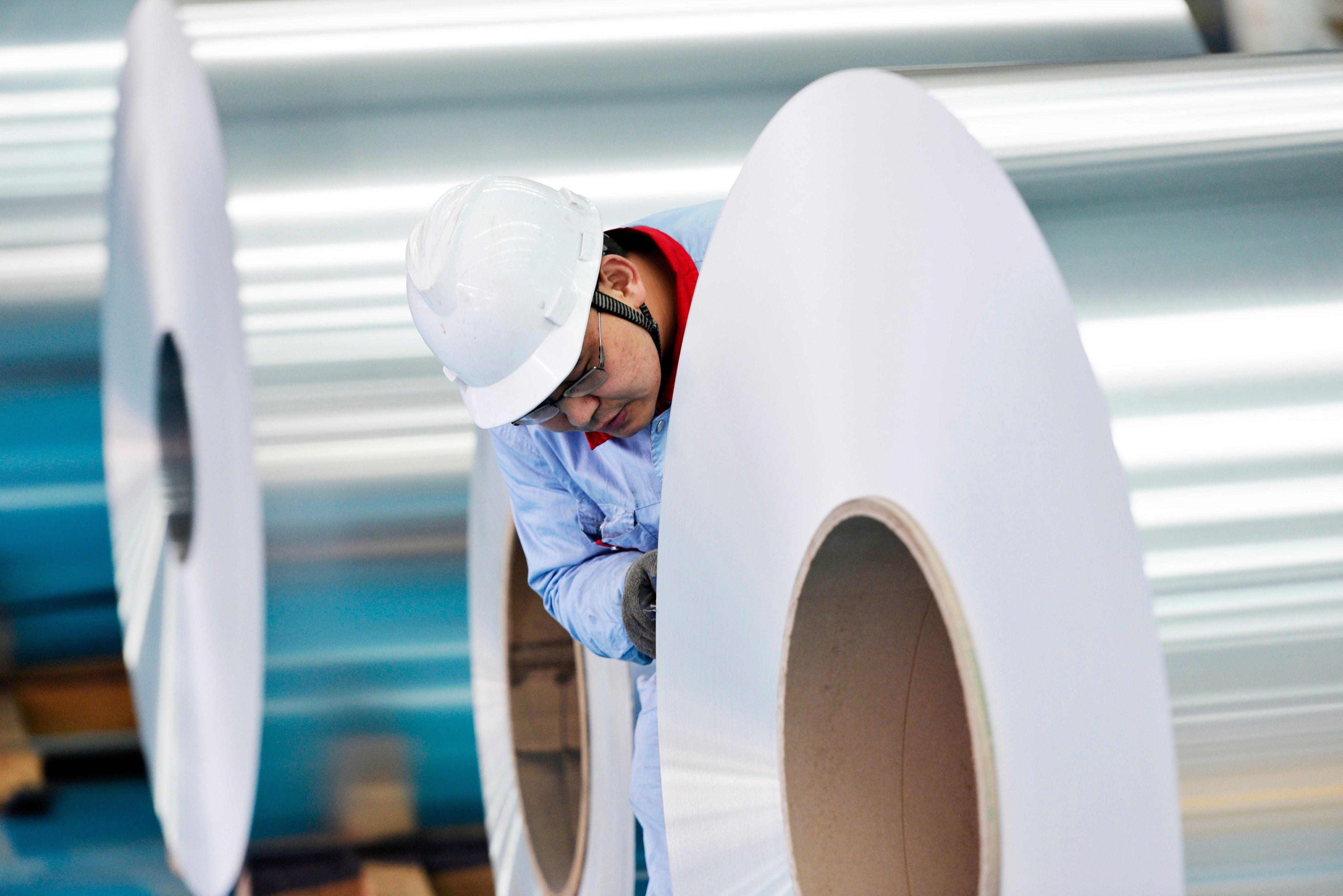 A worker checks coiled aluminium plates at a factory in China’s eastern Shandong province. China’s aluminium giant Chalco and Rio Tinto have agreed to acquire a controlling stake in Brazilian flagship aluminium firm CBA. Photo: Imaginechina