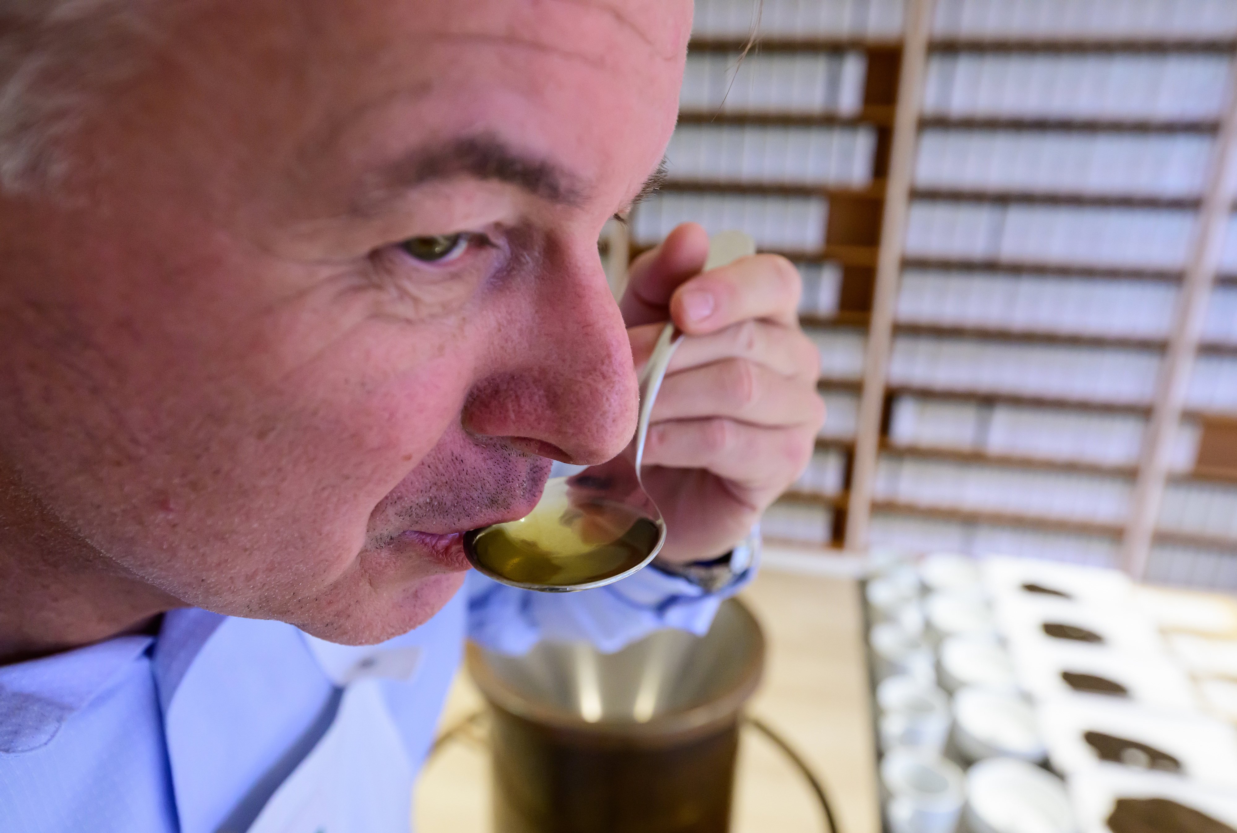 German tea taster Stefan Feldbusch samples a spoonful of tea. The inhabitants of Frisia, in northwestern Germany, drink more tea than beer. Photo: Philipp Schulze/dpa
