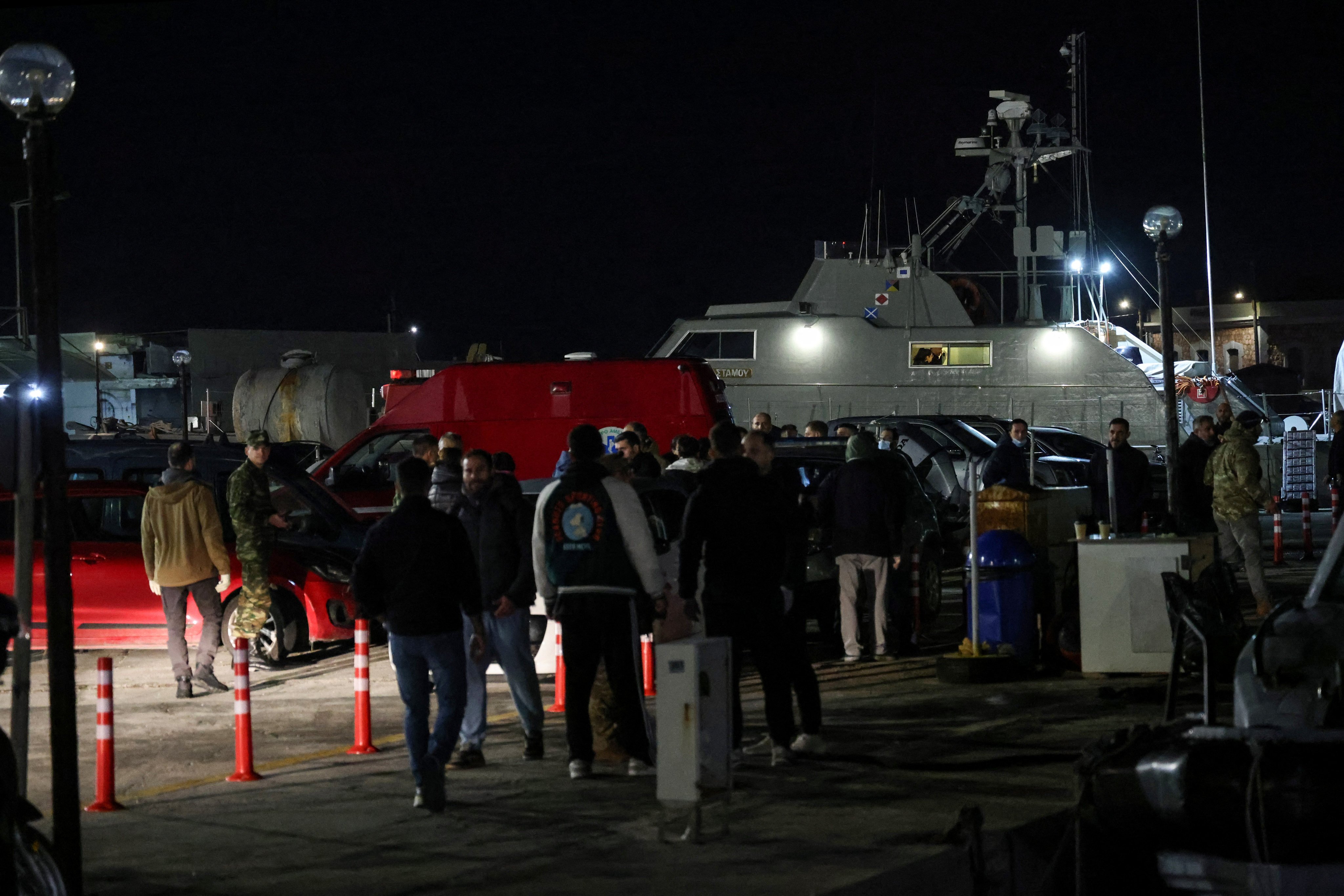 Greek emergency personnel in the port of Chios wait to transfer bodies of dead migrants. Photo: Reuters