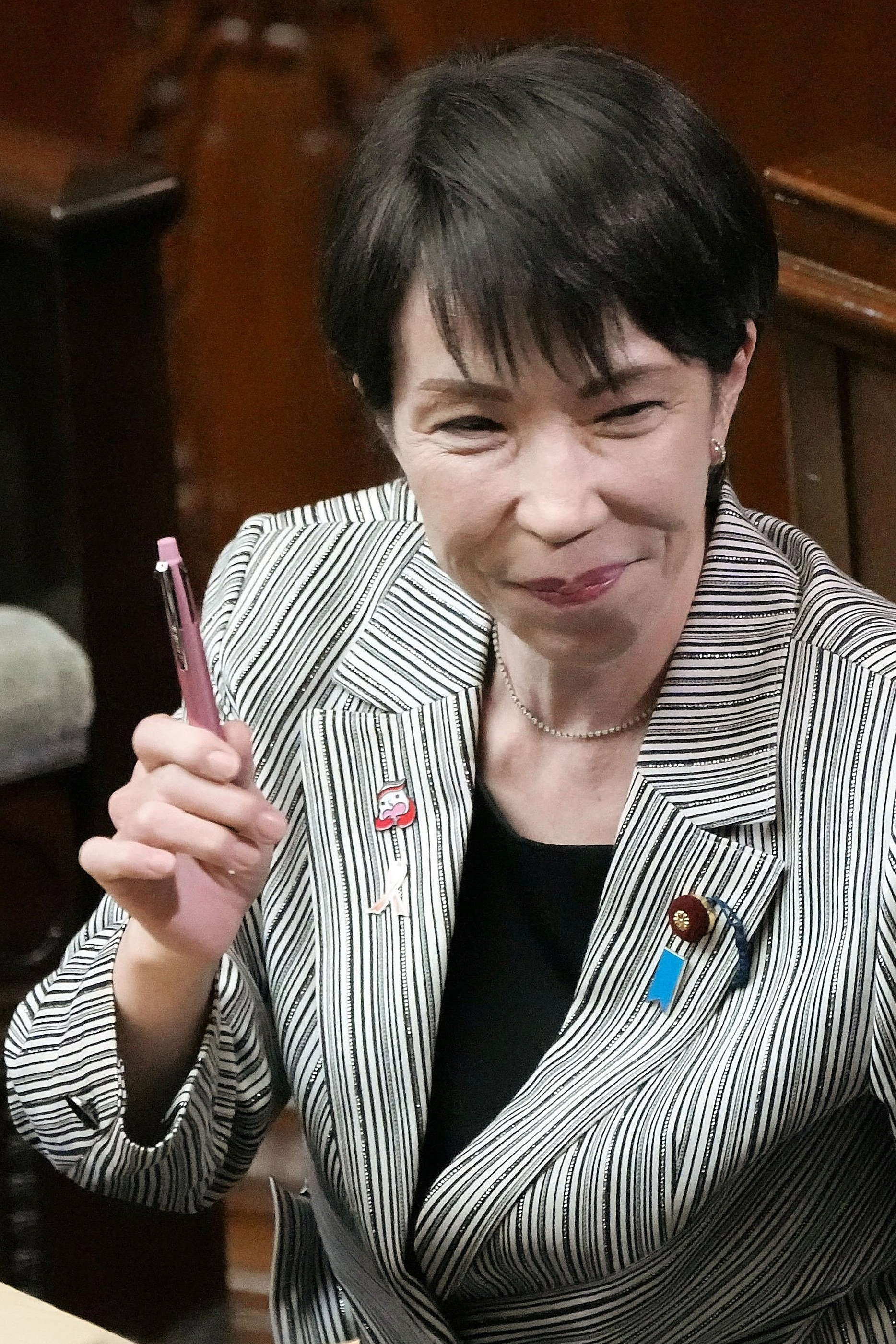 Japan’s Prime Minister Sanae Takaichi holds up her personal pen at a House of Representatives session in November last year. Photo: Kyodo/AP