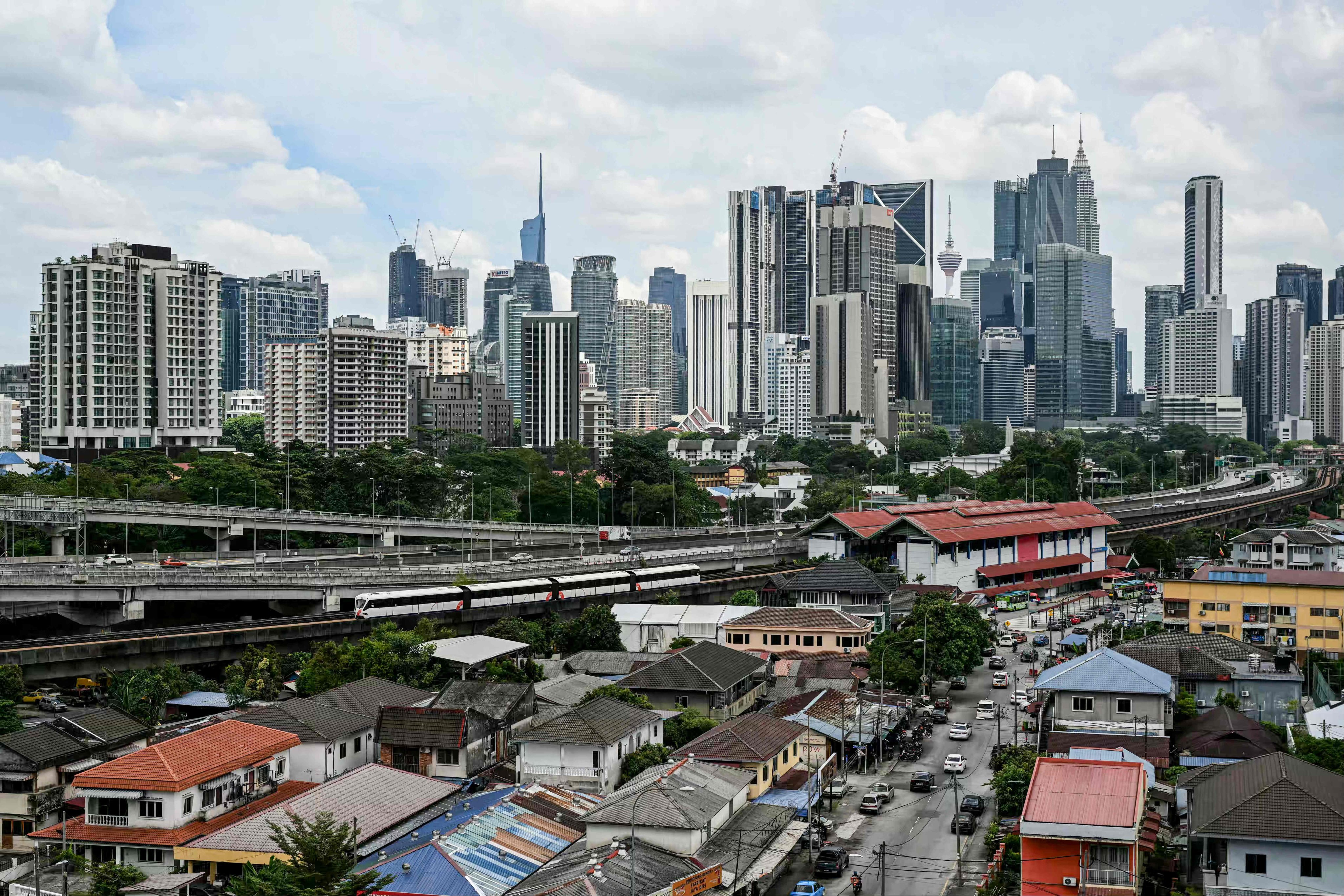 Commercial buildings and residential housing in Kuala Lumpur. MM2H homeowners tend to cluster around prime districts in the Malaysian capital. Photo: AFP