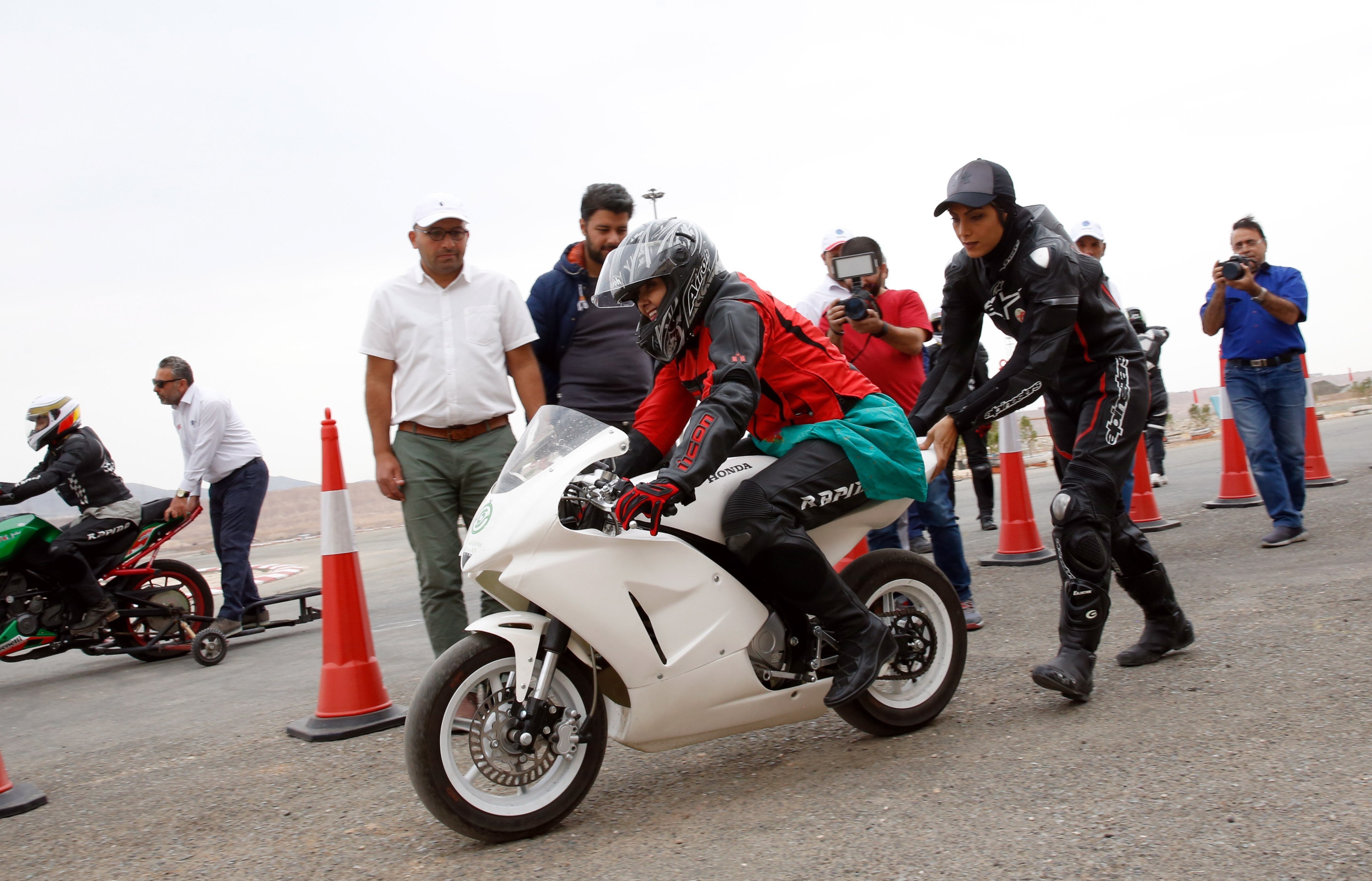 Maryam Talaie helps actress Katayun Riyahi during Iran’s first official women’s motorcycle training near Tehran in 2018. As of Wednesday, women in the country can officially get motorcycle licenses. Photo: EPA-EFE