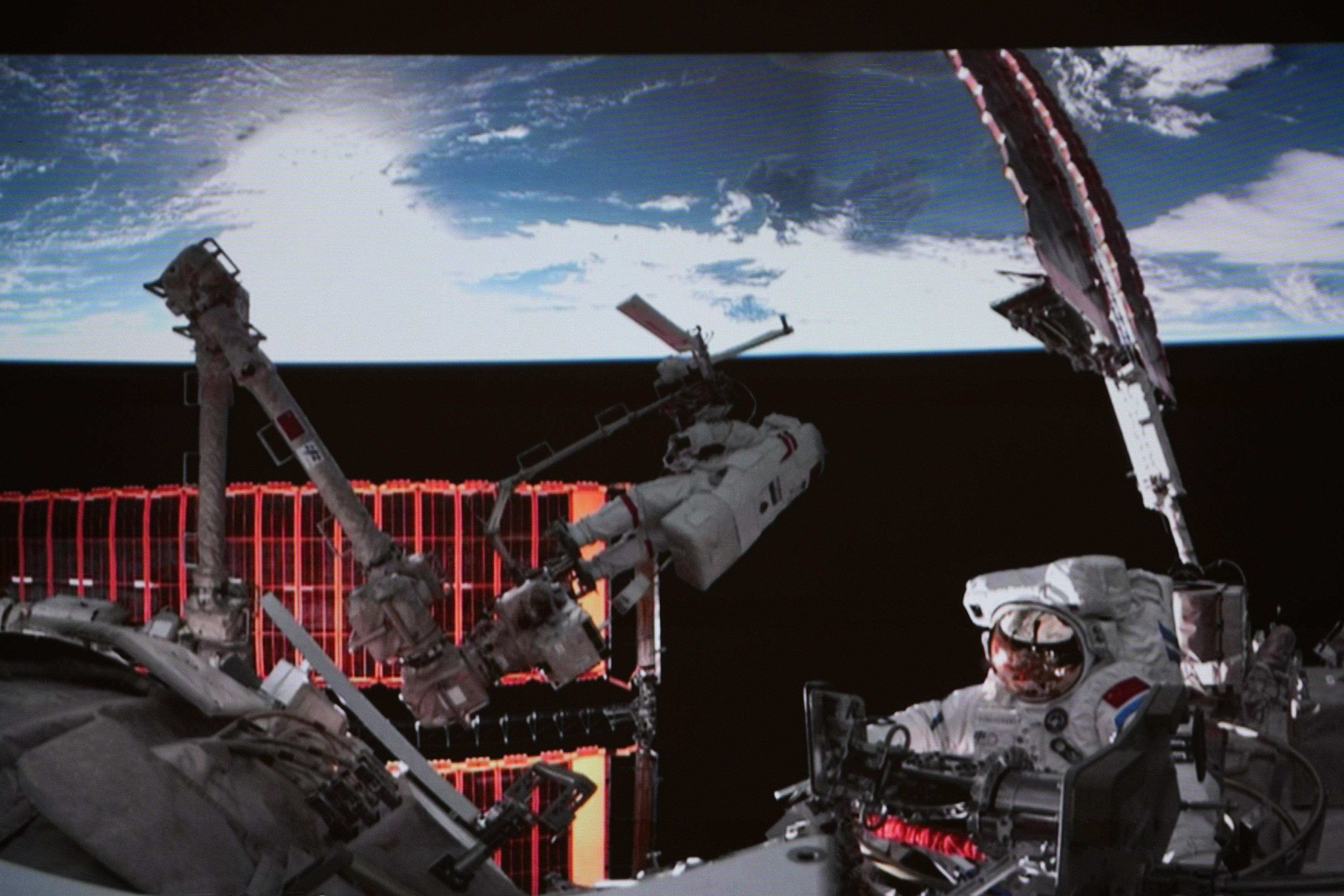 This screen image captured at the Beijing Aerospace Control Centre on December 9, 2025, shows Shenzhou-21 astronauts Zhang Lu and Wu Fei (right) performing extravehicular activities outside China’s orbiting space station, as part of their mission to repair the damage done to the Shenzhou-20 spacecraft by a tiny piece of space debris. Photo: Xinhua