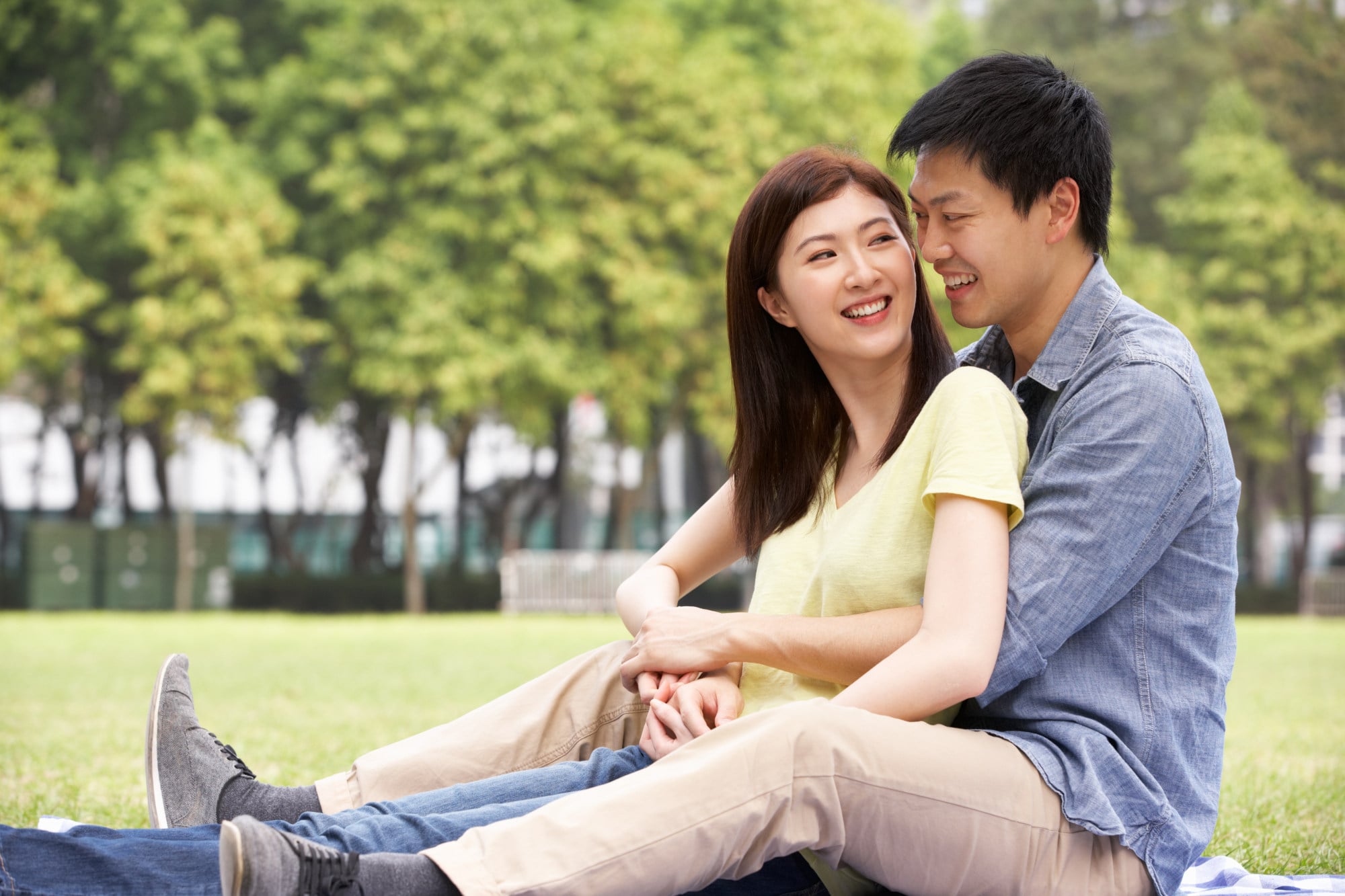 A content young Chinese couple relax in a park. For many others, the path to romantic happiness is not an easy one. Photo: Shutterstock