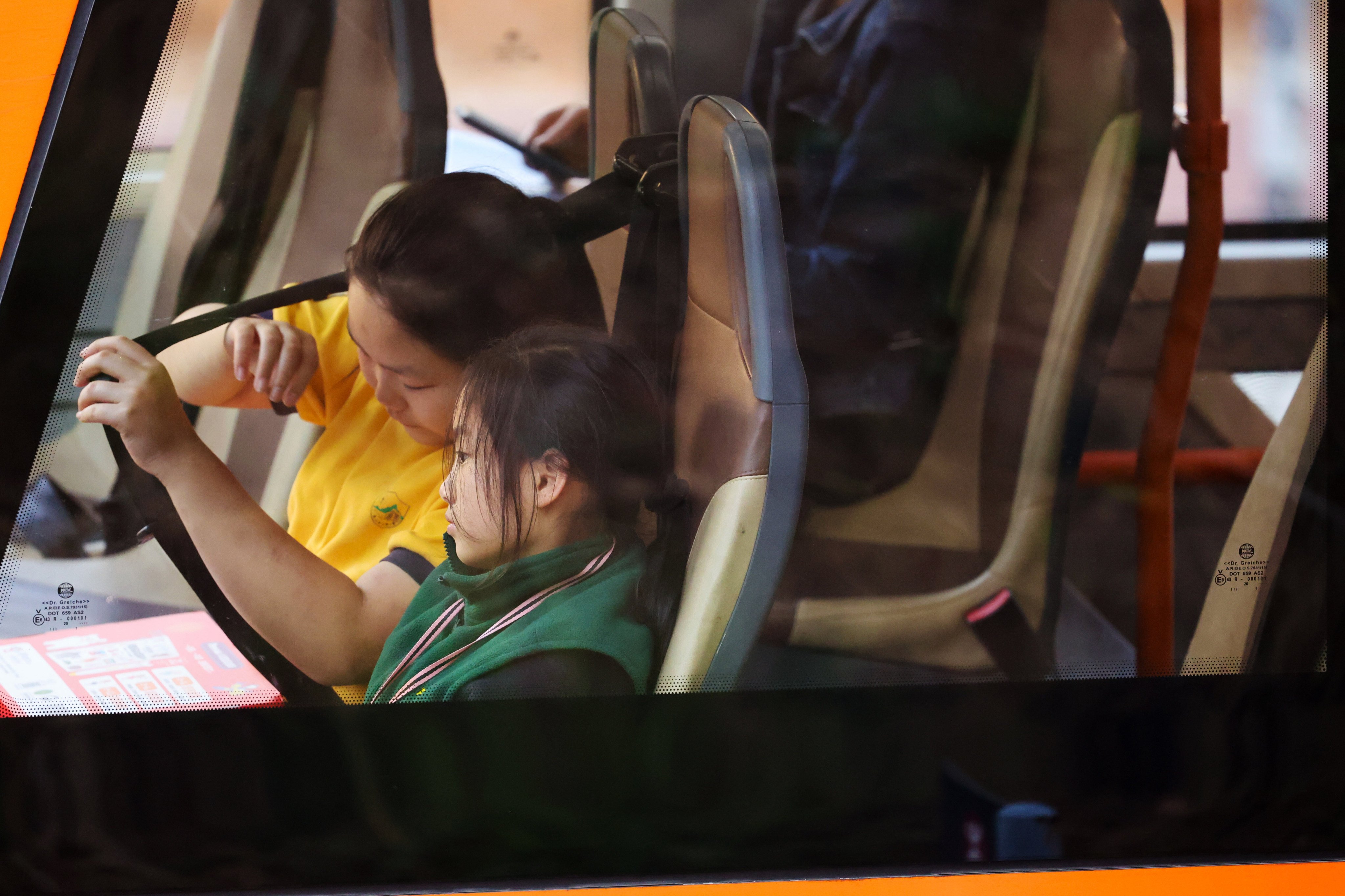 A student tugs at a seat belt on a double-decker bus in Tuen Mun on January 26. Photo: Dickson Lee