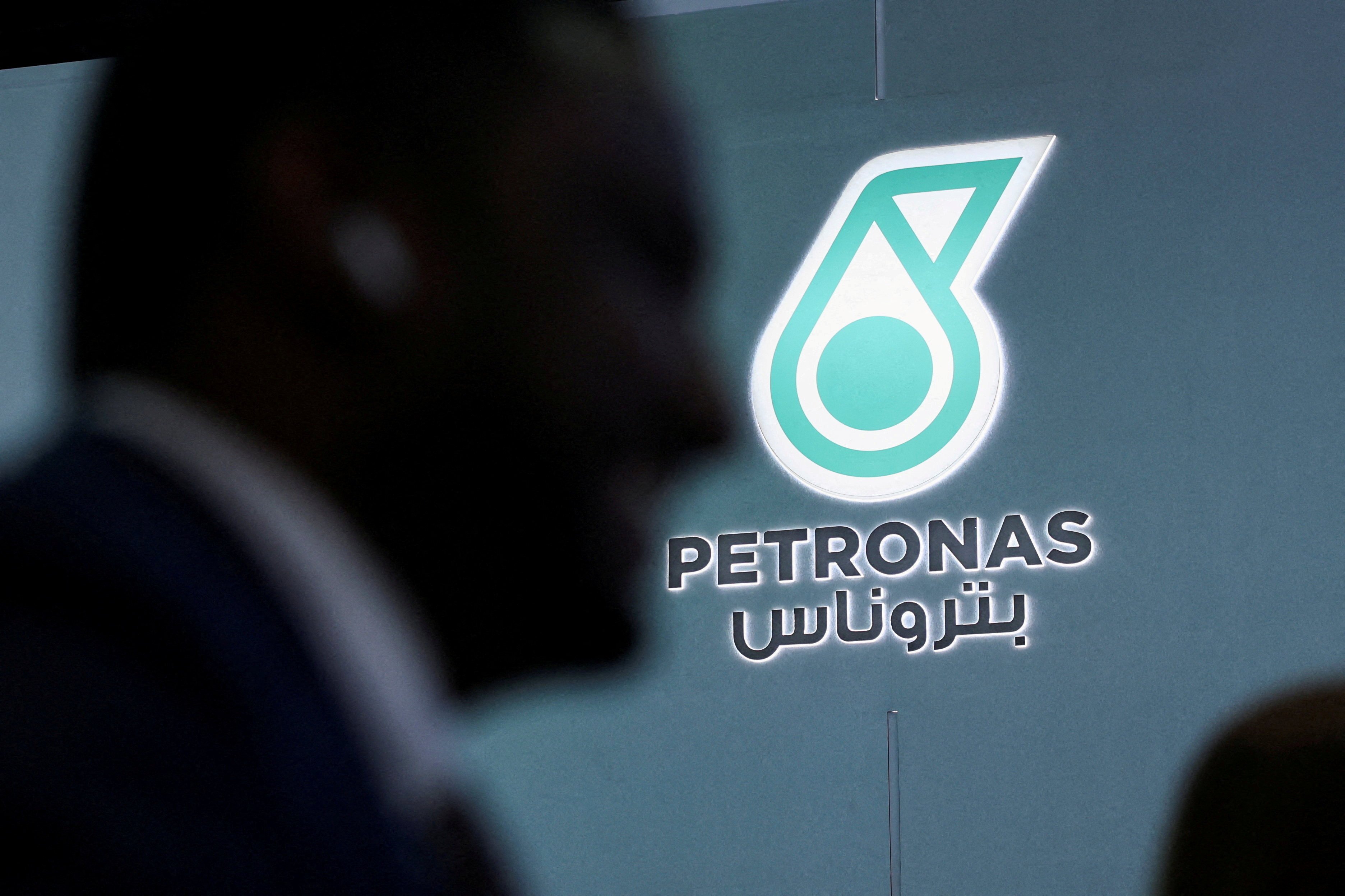 A man walks past a Petronas logo during the annual Abu Dhabi International Petroleum Exhibition and Conference in November last year. Photo: Reuters