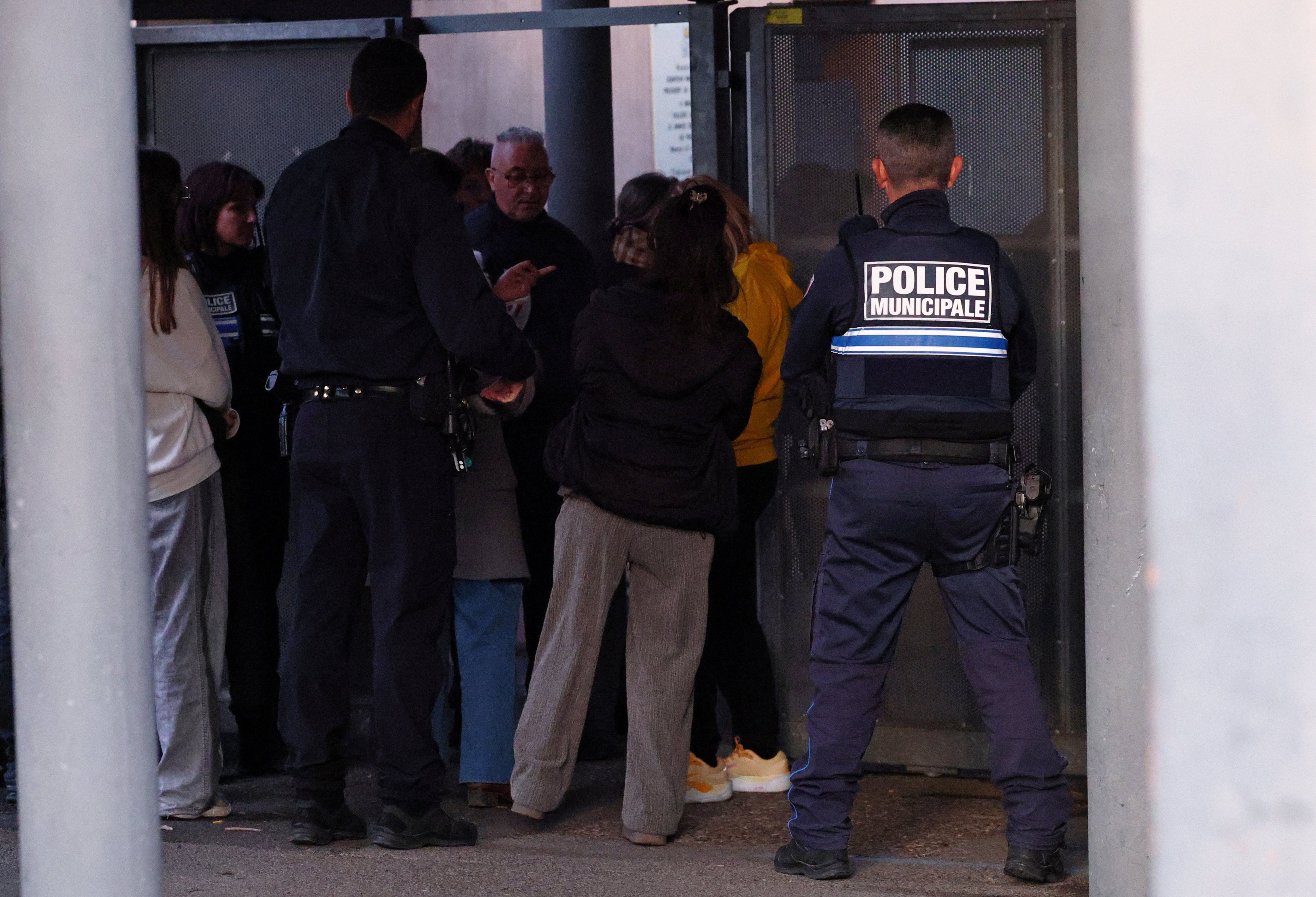 Police talk to students after the stabbing at La Guicharde secondary school. Photo: Reuters