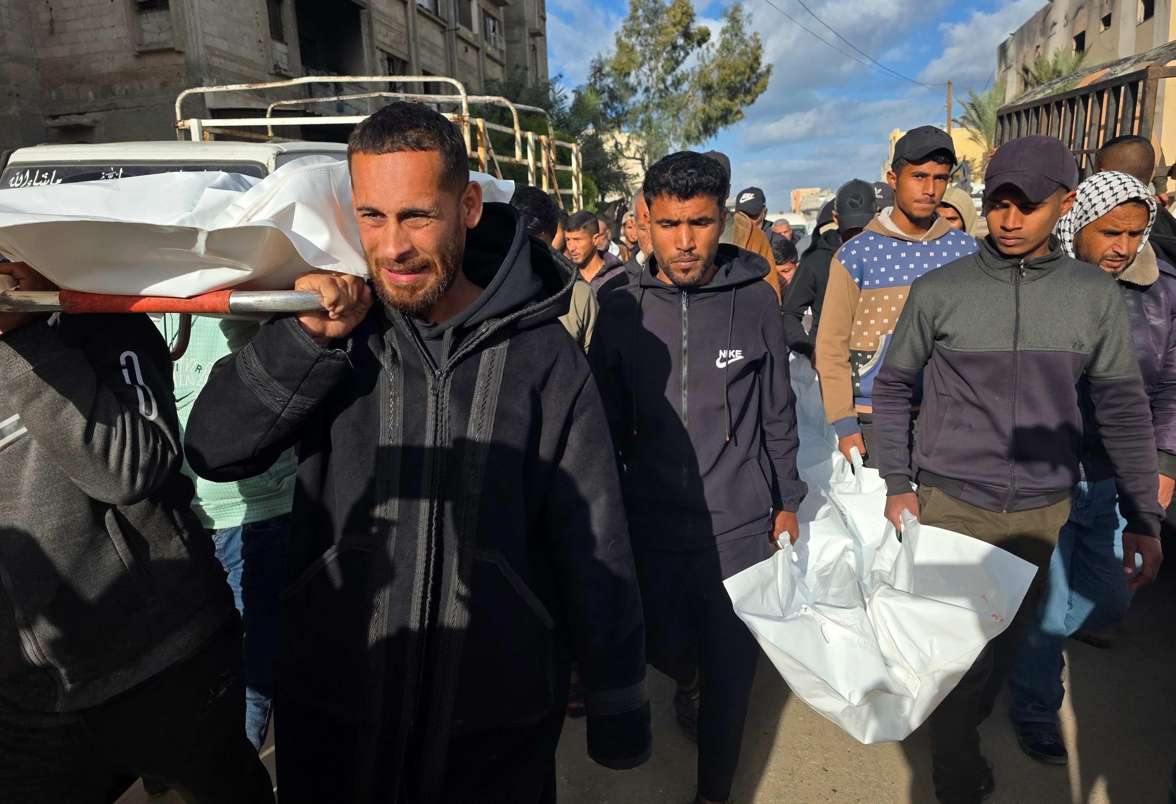 Palestinians carry the bodies of three people killed in an Israeli strike on their displacement tent on Wednesday. Photo: dpa