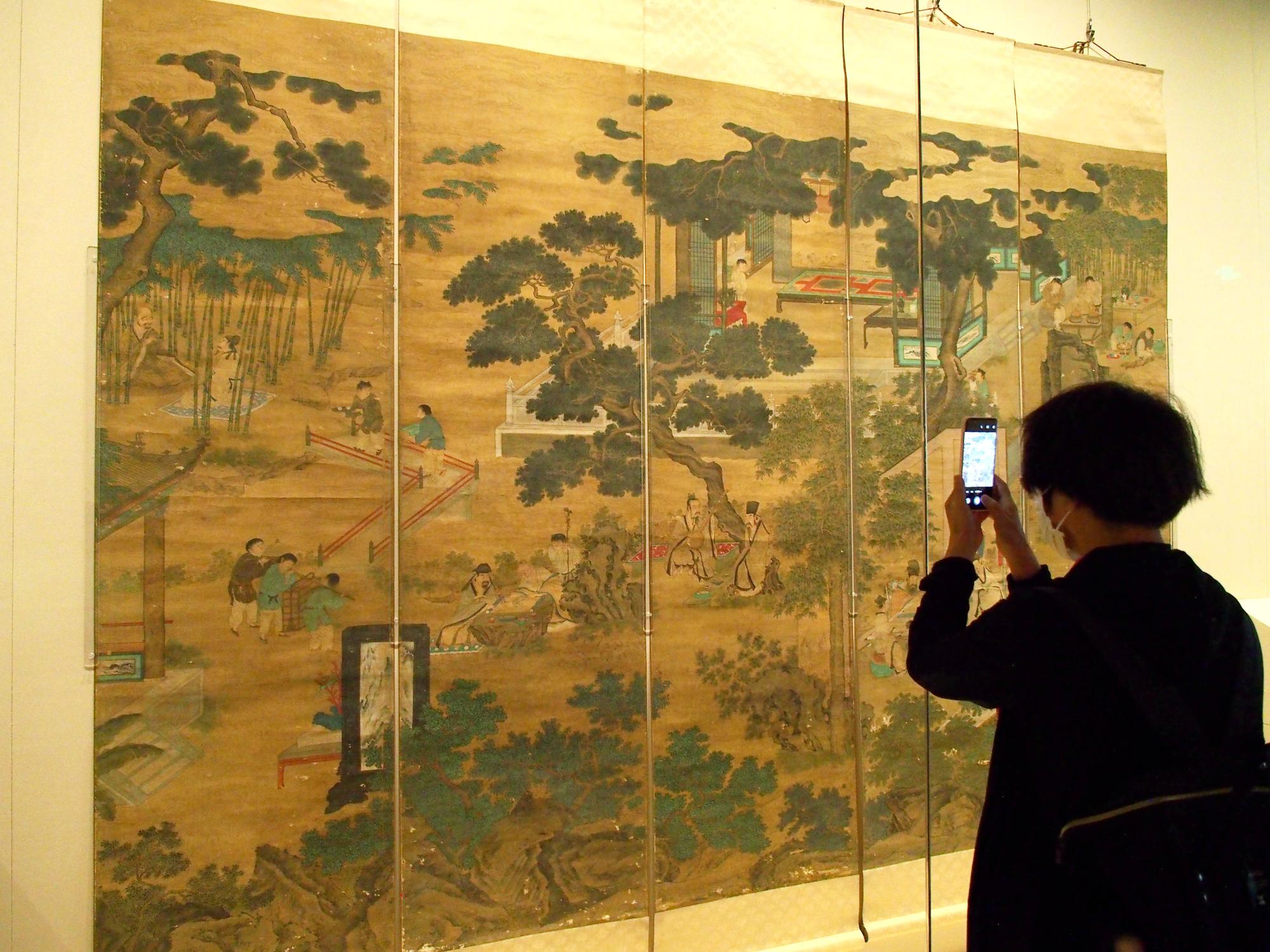 A visitor takes a photograph of figure paintings of Chinese dynasties at the Painting and Calligraphy Hall of the Palace Museum Wenhua Hall in Beijing. Photo: Getty Images A visitor takes a photograph of figure paintings of Chinese dynasties at the Painting and Calligraphy Hall of the Palace Museum Wenhua Hall in Beijing. Photo: Getty Images
