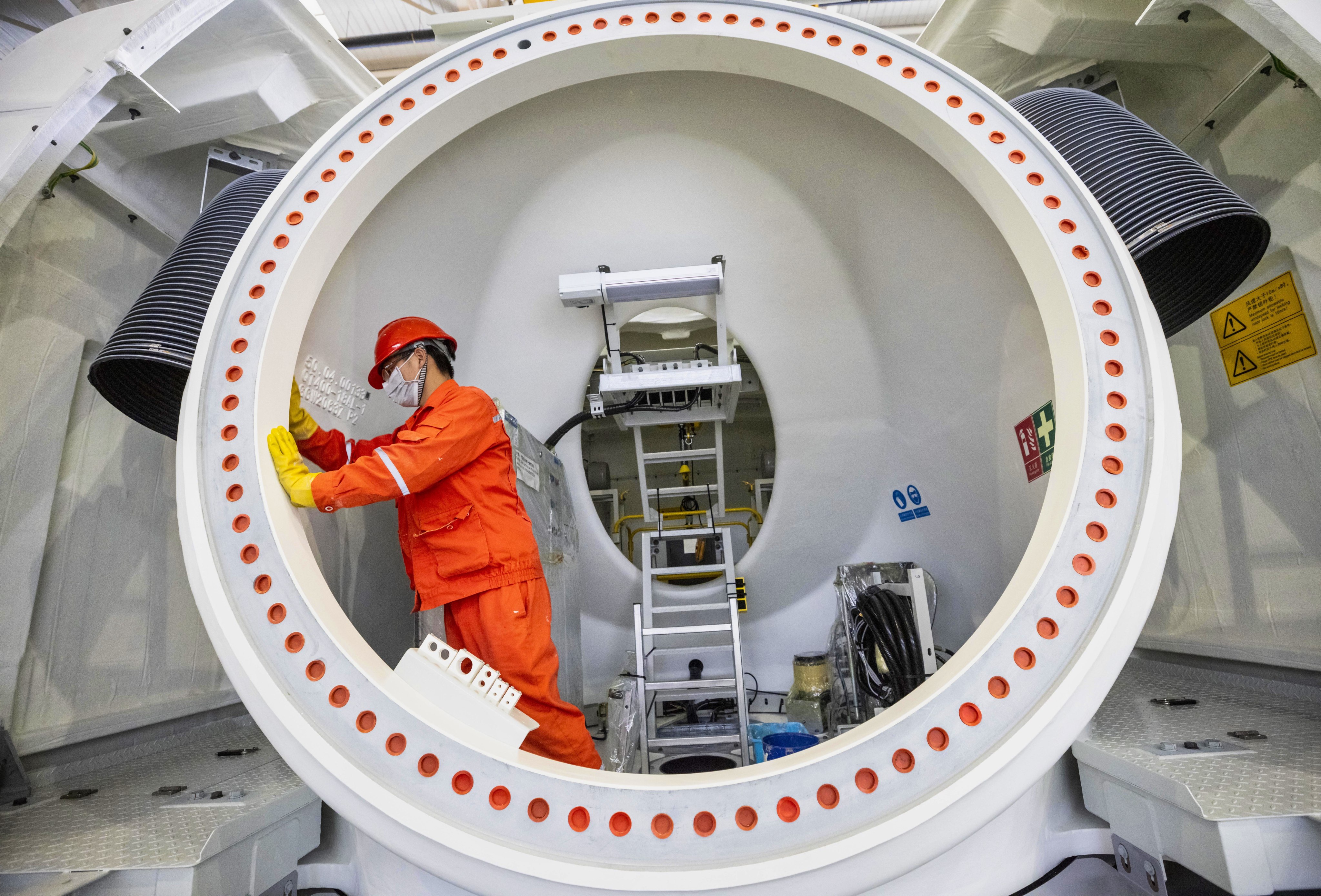 A worker inspects parts at Goldwind Science & Technology’s wind turbine factory in China’s eastern Jiangsu province. Photo: EPA-EFE
