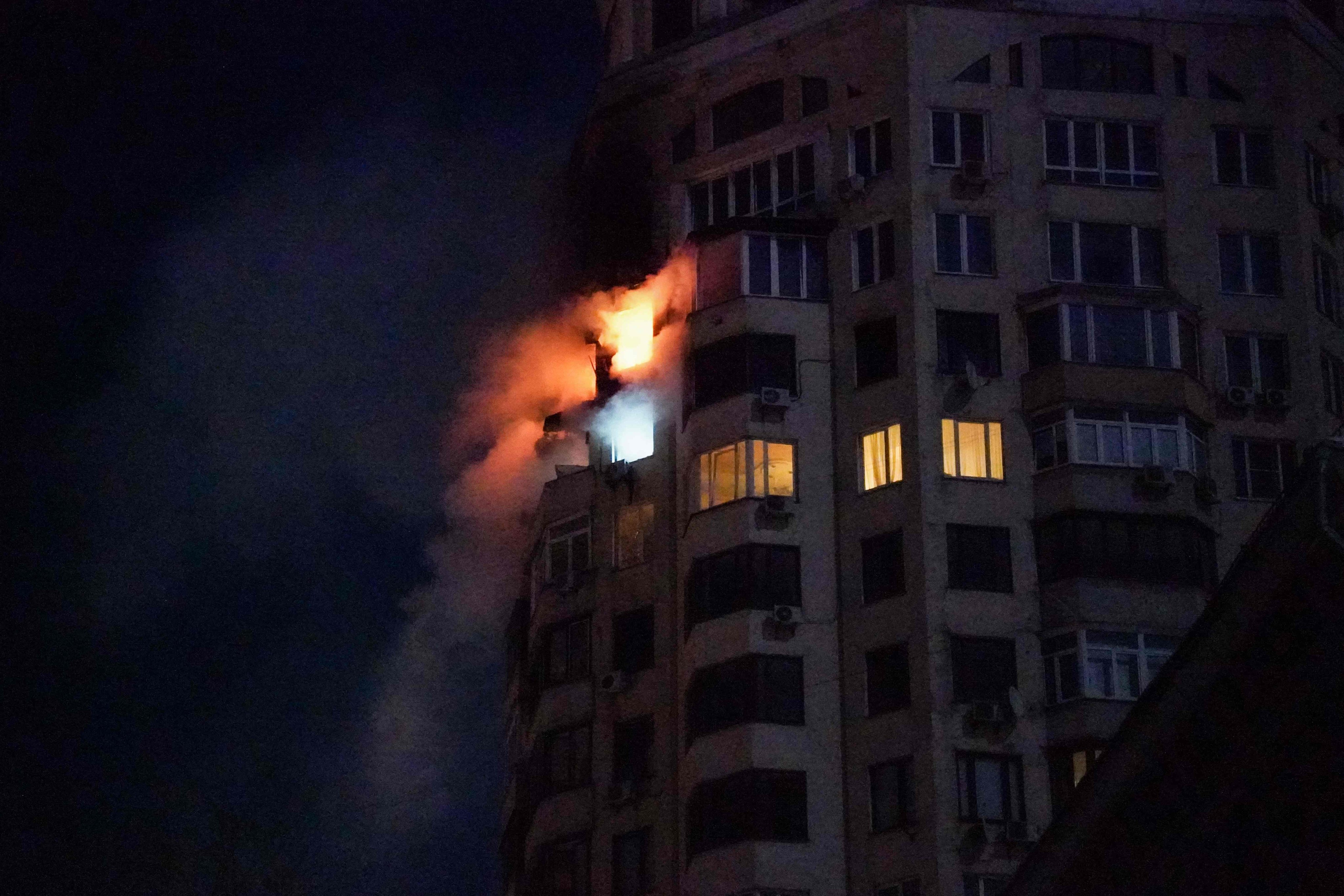Flames are seen at an apartment building following a Russian air attack in Kyiv early on Tuesday. Photo: AFP