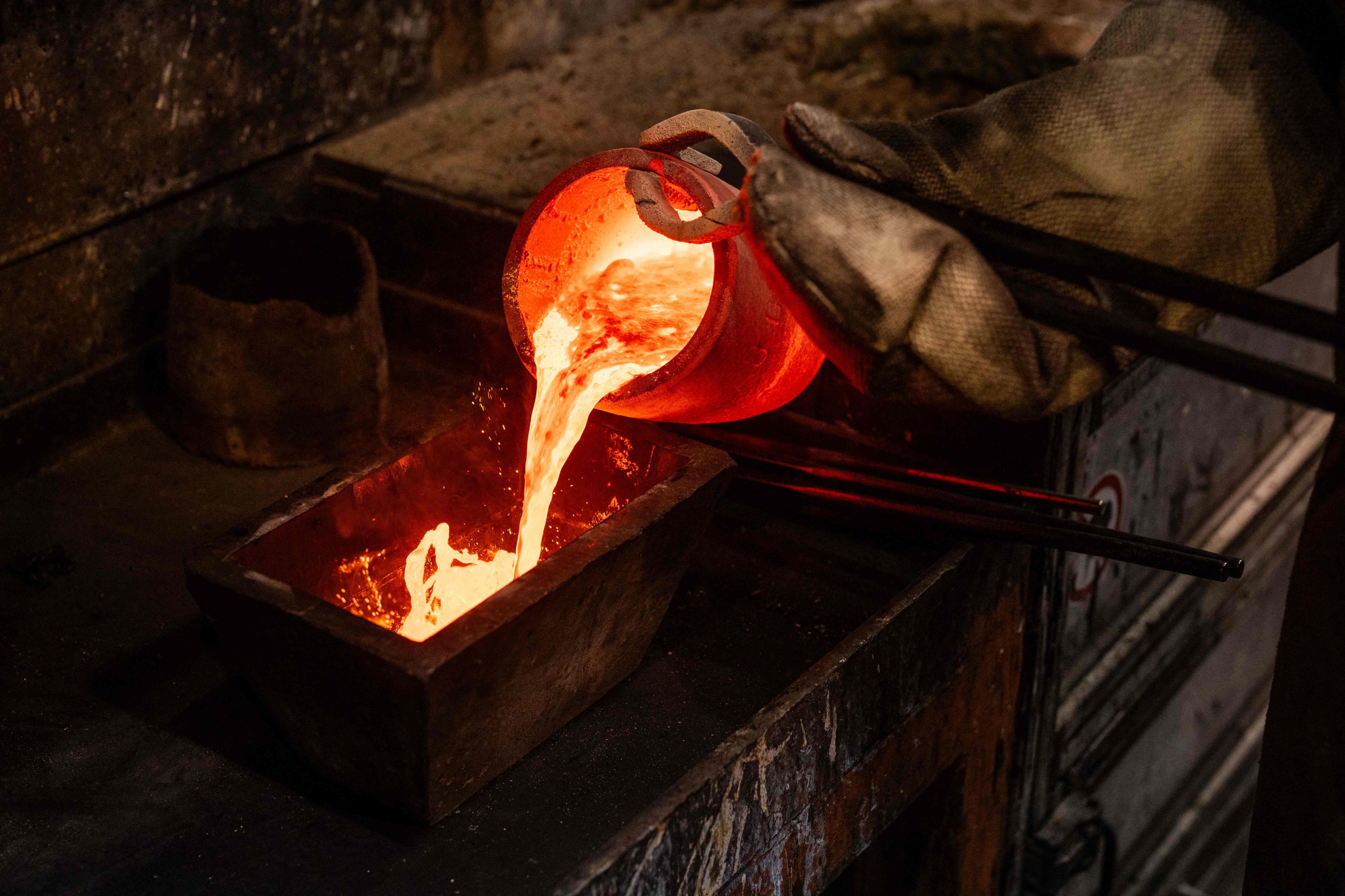 Molten gold made from jewelry is poured into a mold to produce a gold bar at the Austrian Gold and Silver Refinery in Vienna, Austria on February 3. Photo: AFP