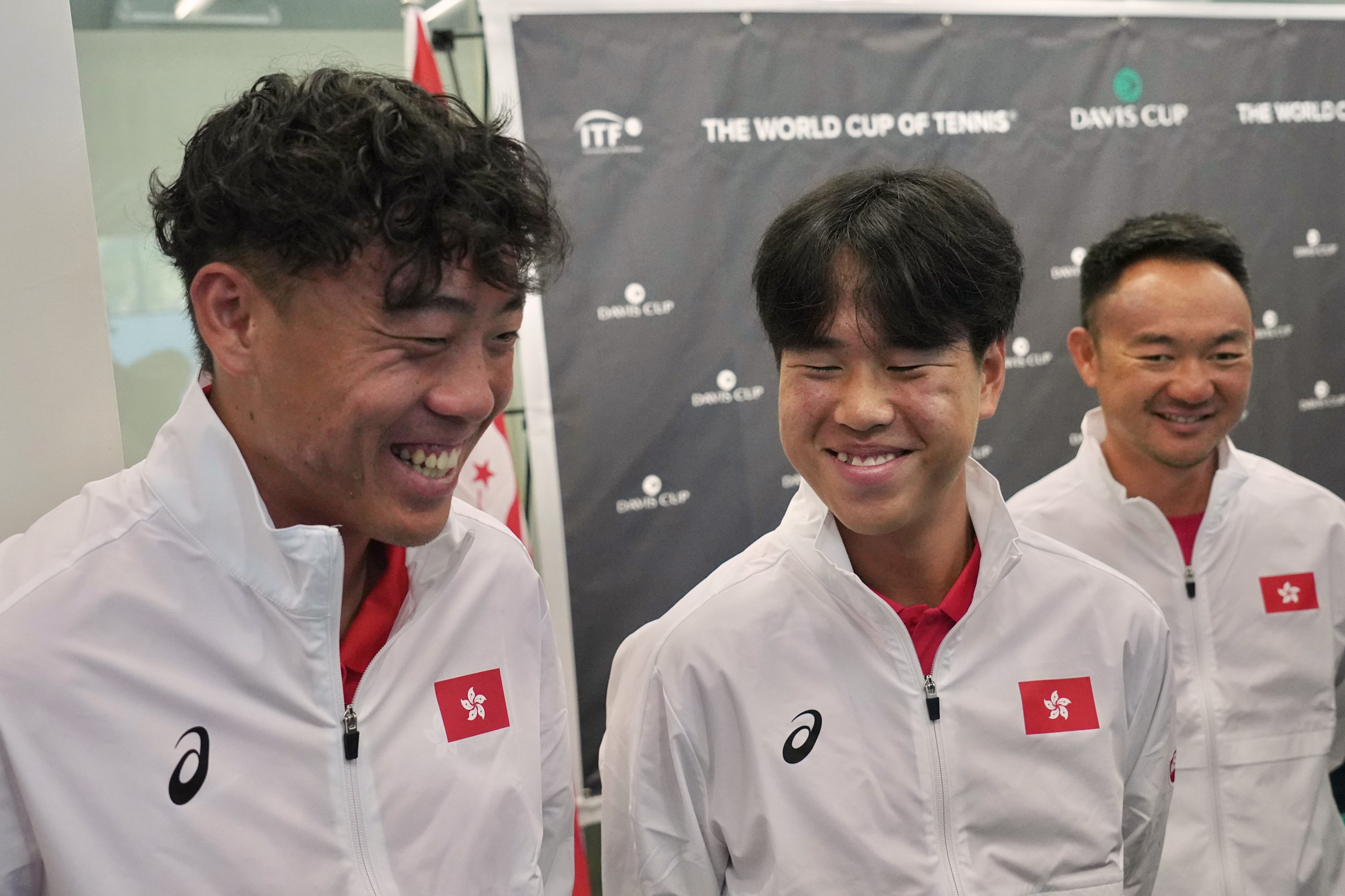 Team captain Yu Hiu-tung hands Nicholas Cheng singles and doubles assignments for Victoria Park Tennis Stadium tie against Finland. 