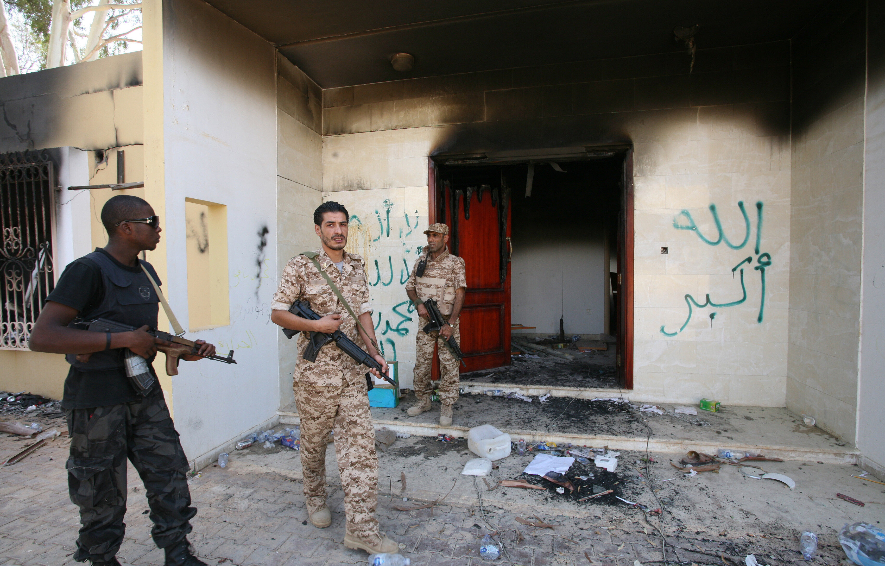 Libyan military guards check one of the US government’s burnt-out buildings in September 2012 in Benghazi, Libya. Photo: AP