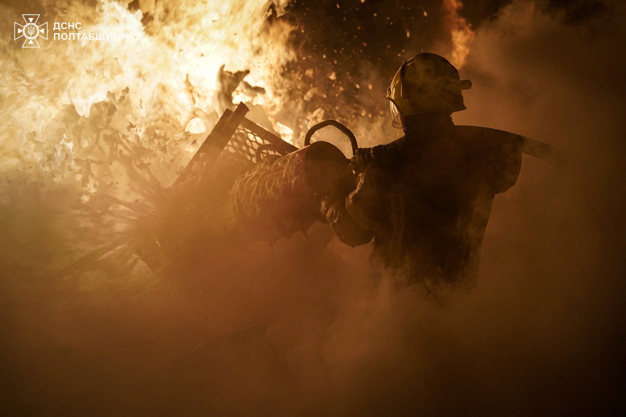 A firefighter battles flames at an industrial building hit by overnight Russian drone strikes in Ukraine’s Poltava region on Friday. Photo: Press service of the State Emergency Service of Ukraine in Poltava region/Reuters