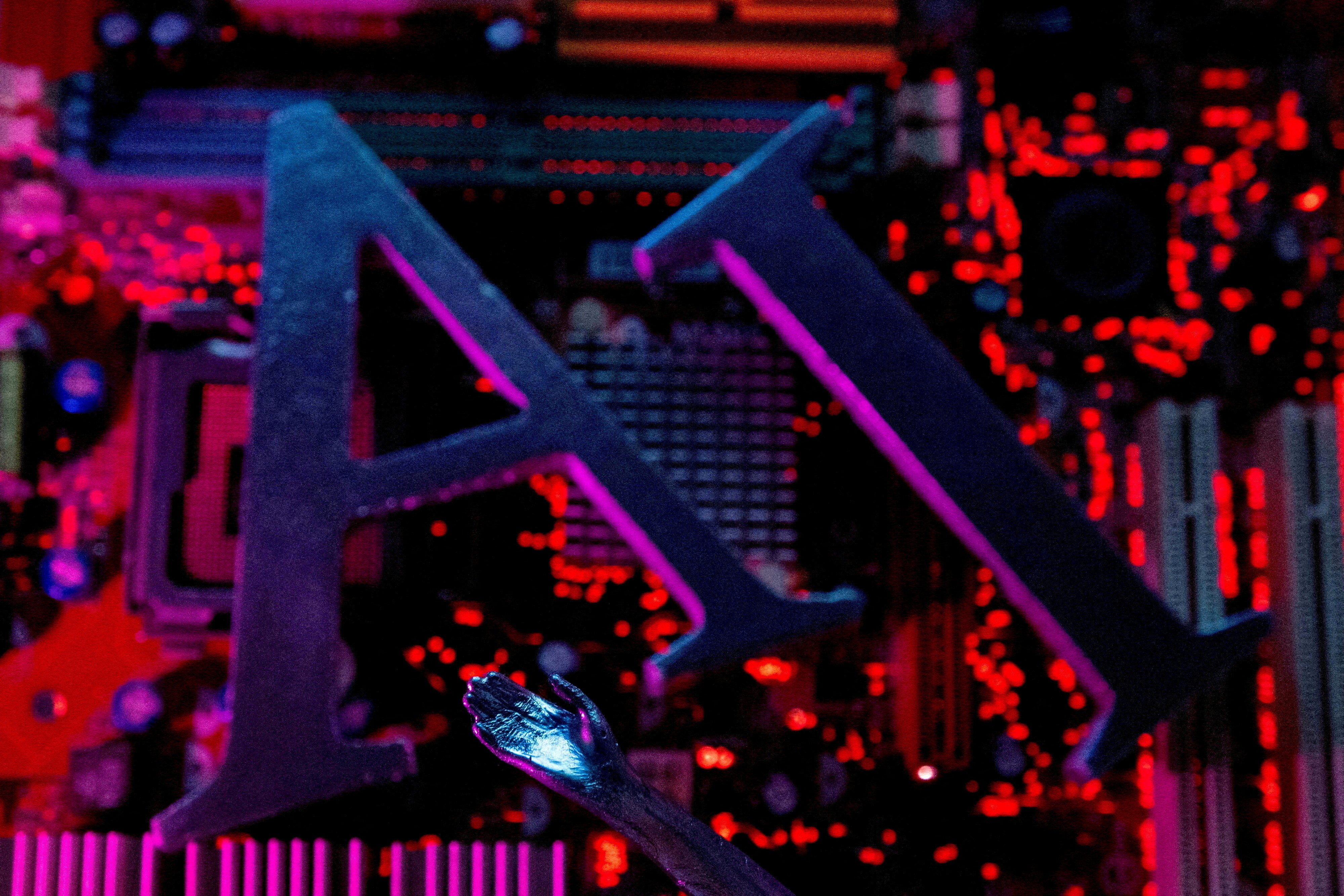 AI letters and a robot hand are seen on computer motherboard in this illustration created on June 23, 2023. Photo: Reuters