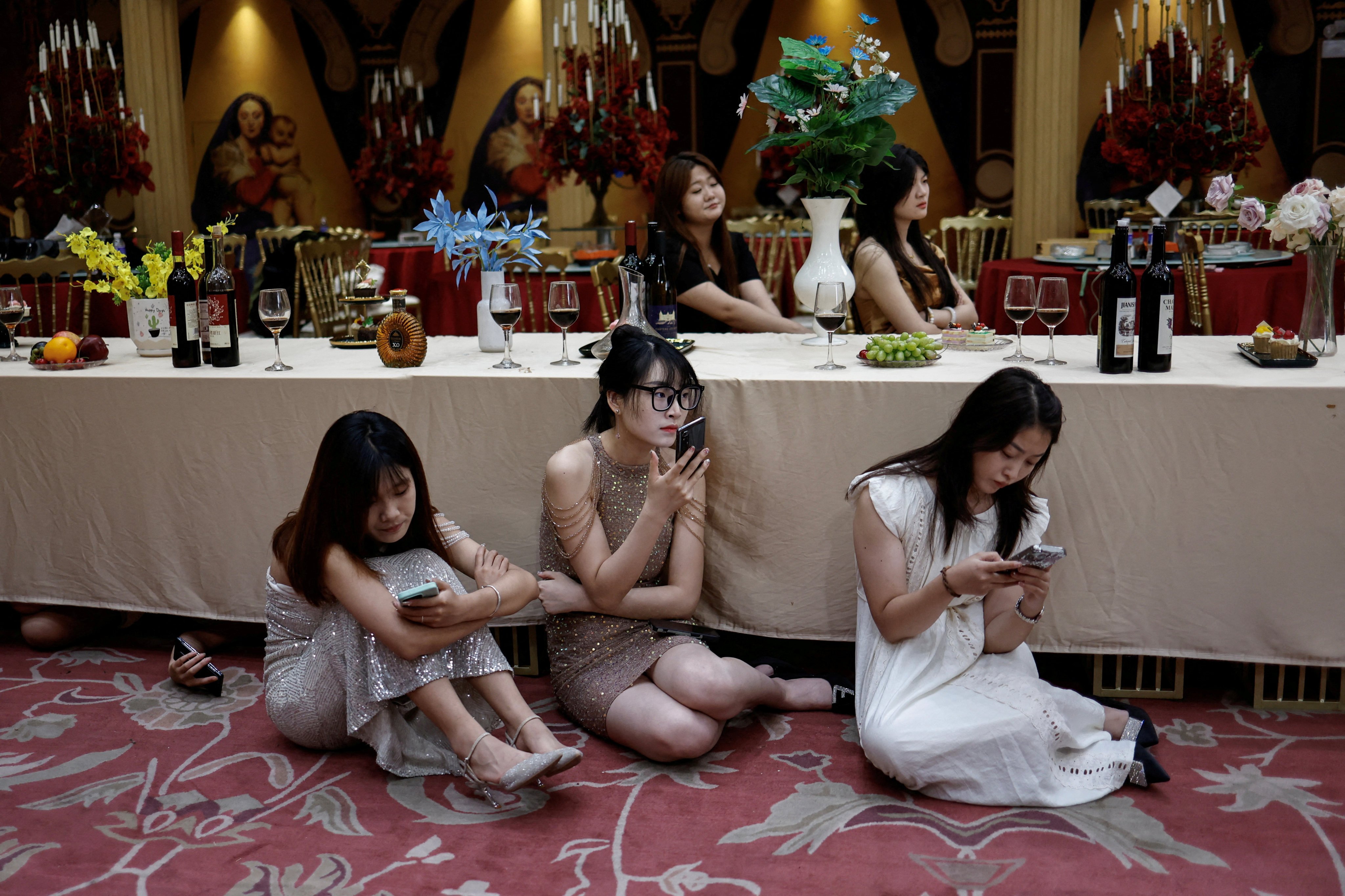 Actors wait on the set of a micro drama during a filming session at a banquet hall in Zhengzhou, Henan province, on July 16, 2024. Photo: Reuters