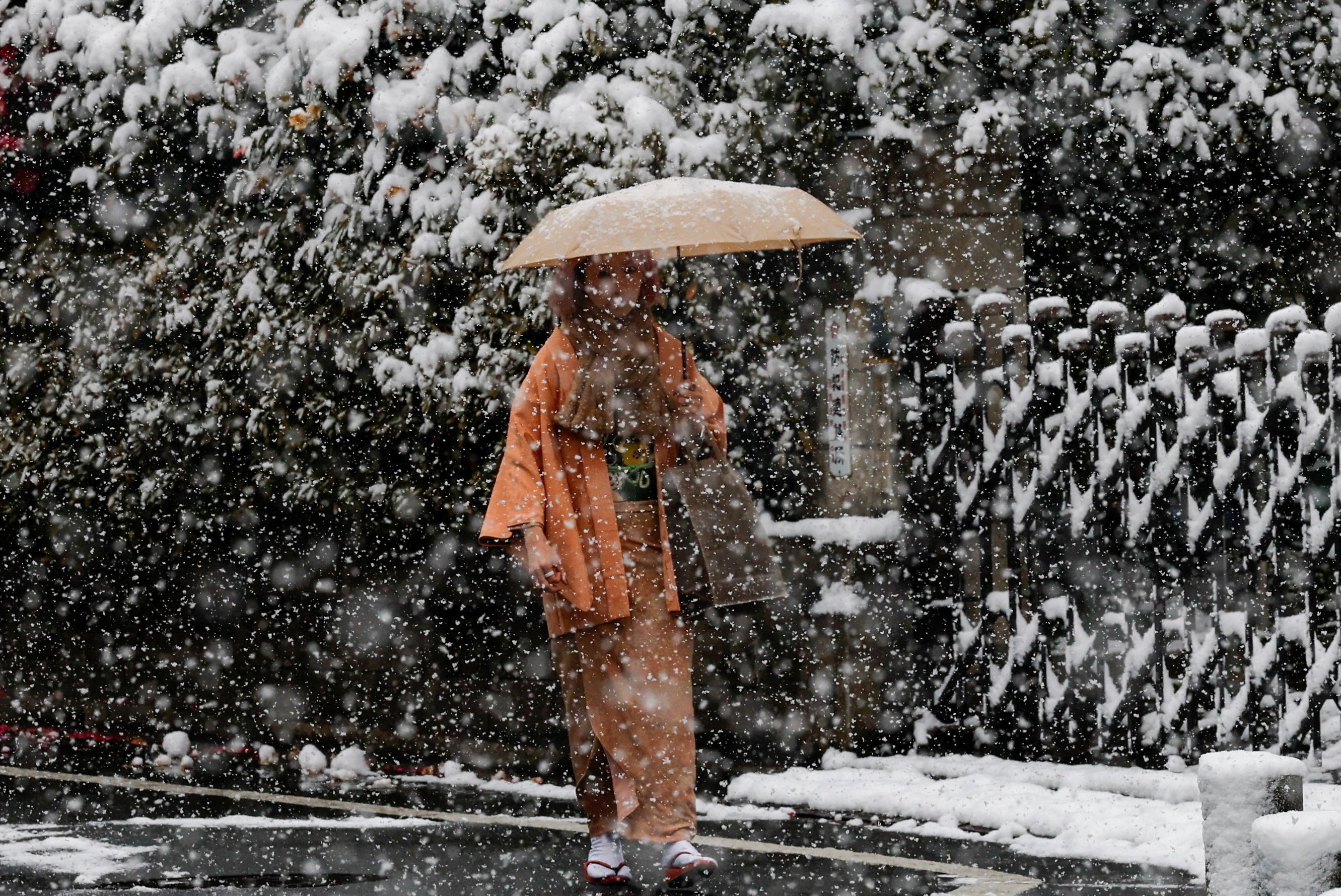 A voter wearing a traditional kimono walks to a polling station in Tokyo on Sunday. Photo: Reuters