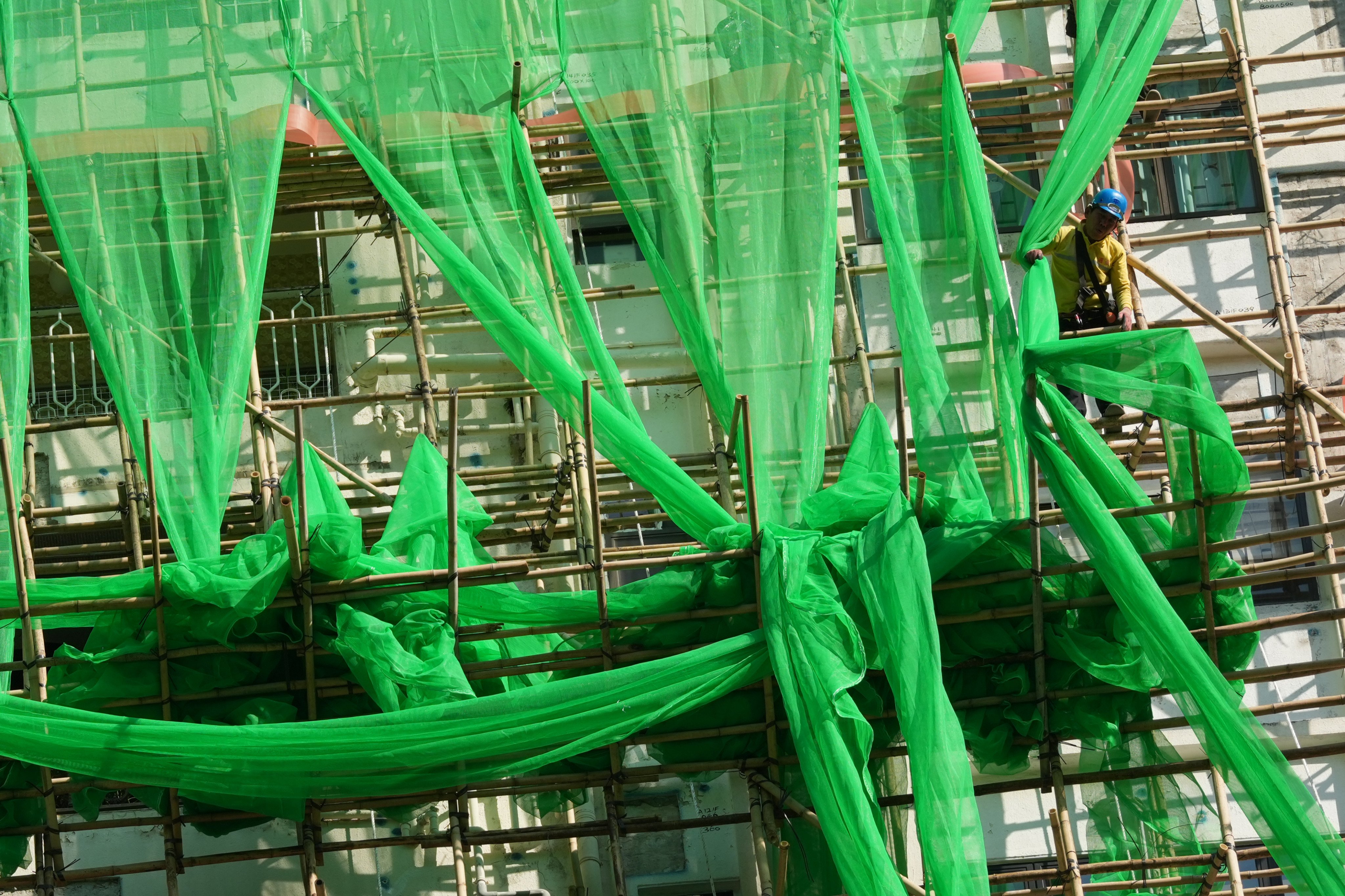 Workers put up new fire-retardant scaffolding nets in Tin Hau last month. Photo: Jelly Tse