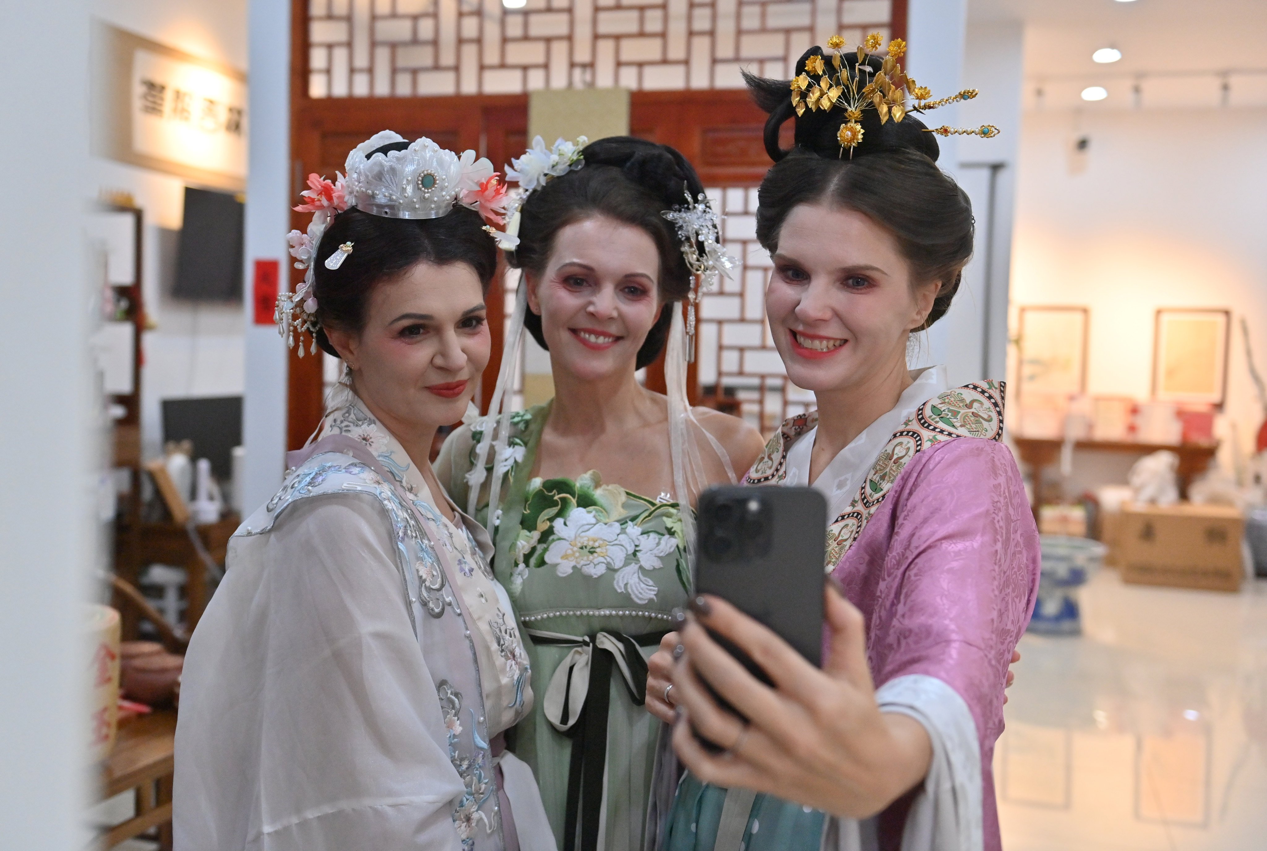 German tourists dressed in Hanfu costumes (traditional Chinese costumes) take a selfie at a Hanfu experience hall in Changchun, Jilin Province of China. Photo: China News Service/VCG via Getty Images