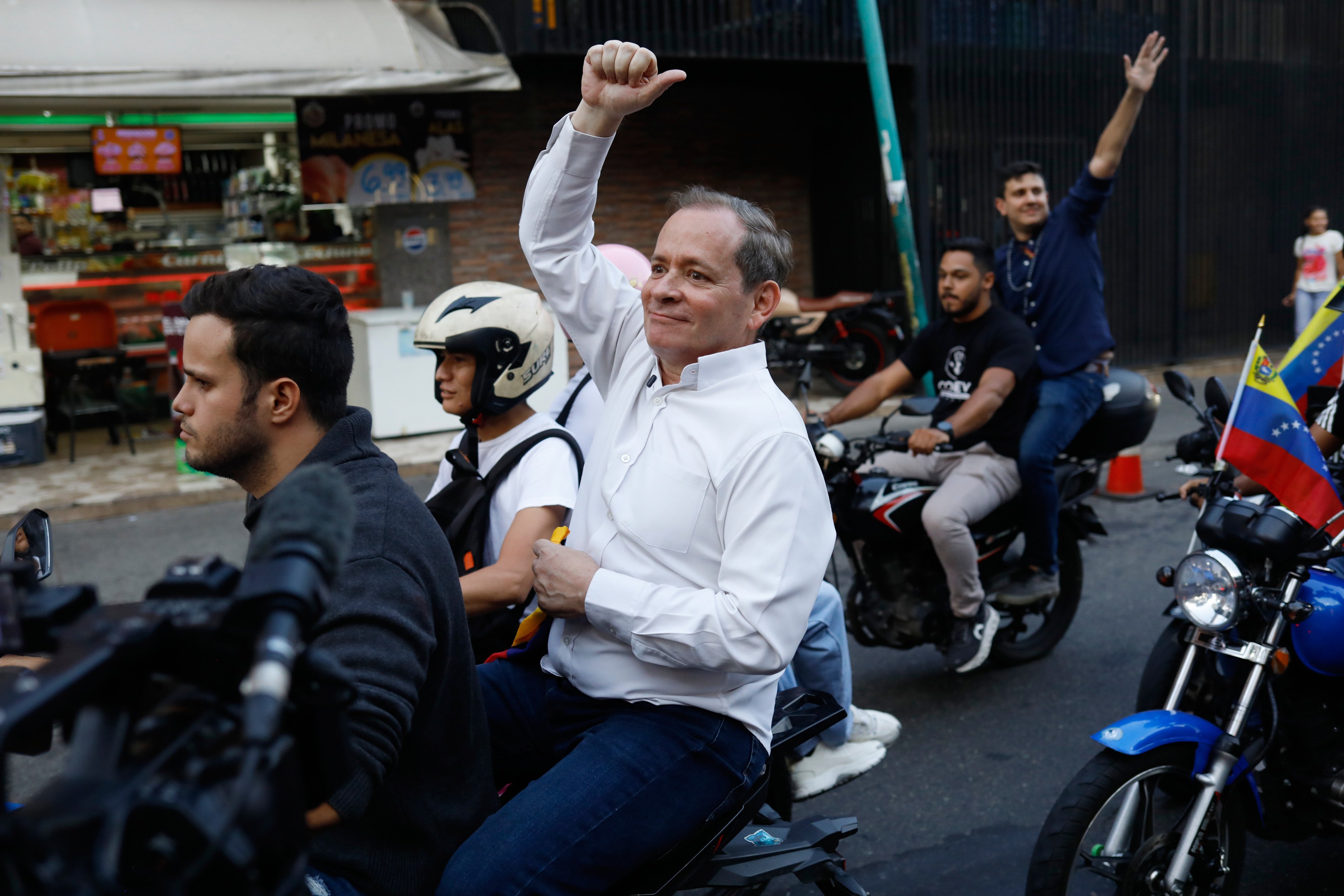 Juan Pablo Guanipa, an ally of opposition leader Maria Corina Machado, rides on the back of a motorcycle after his release from prison in Caracas, Venezuela on Sunday. Photo: AP