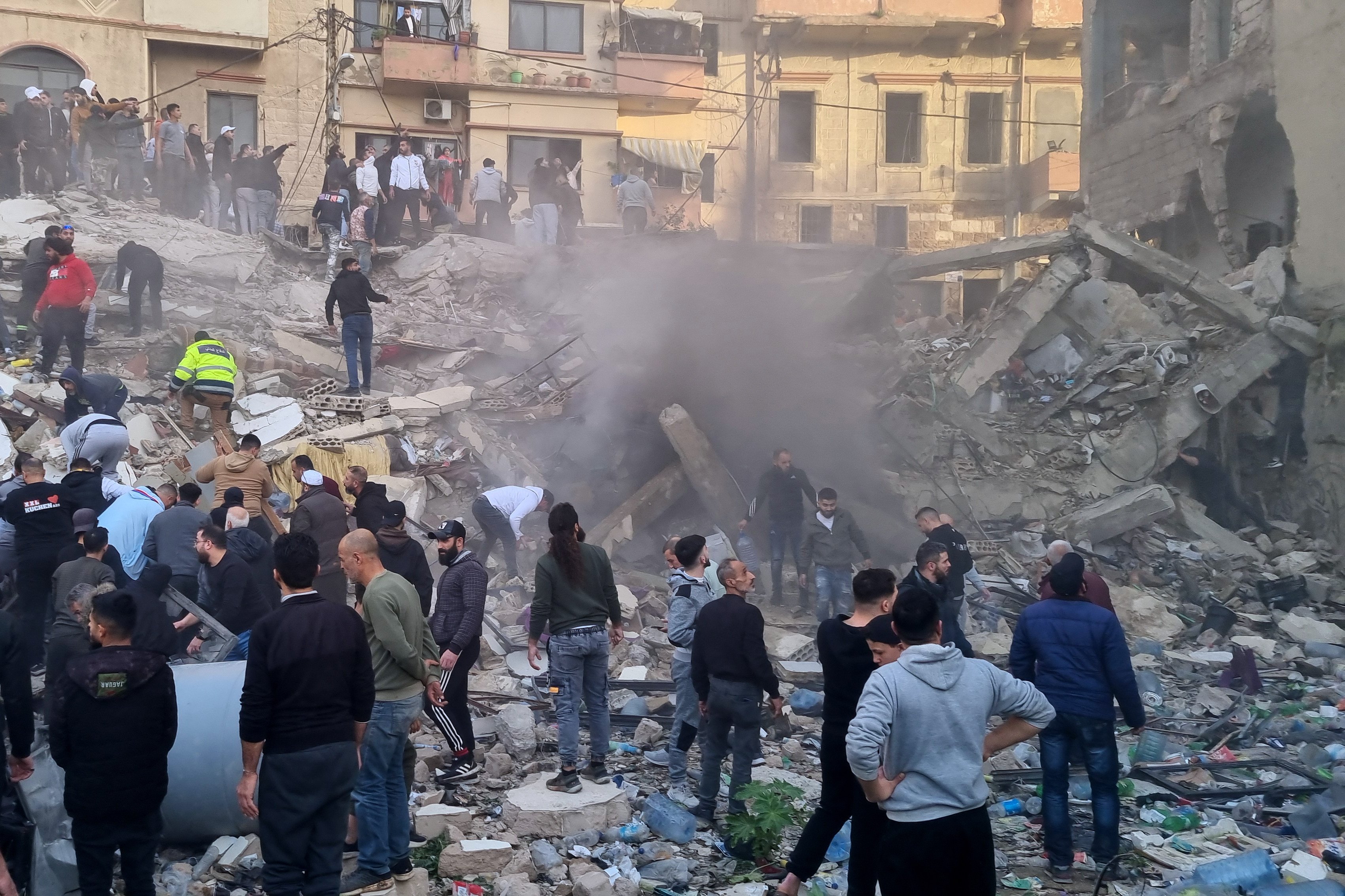 Rescuers and residents search for survivors in the rubble of a building that collapsed in the northern city of Tripoli, Lebanon on Sunday. Photo: AP