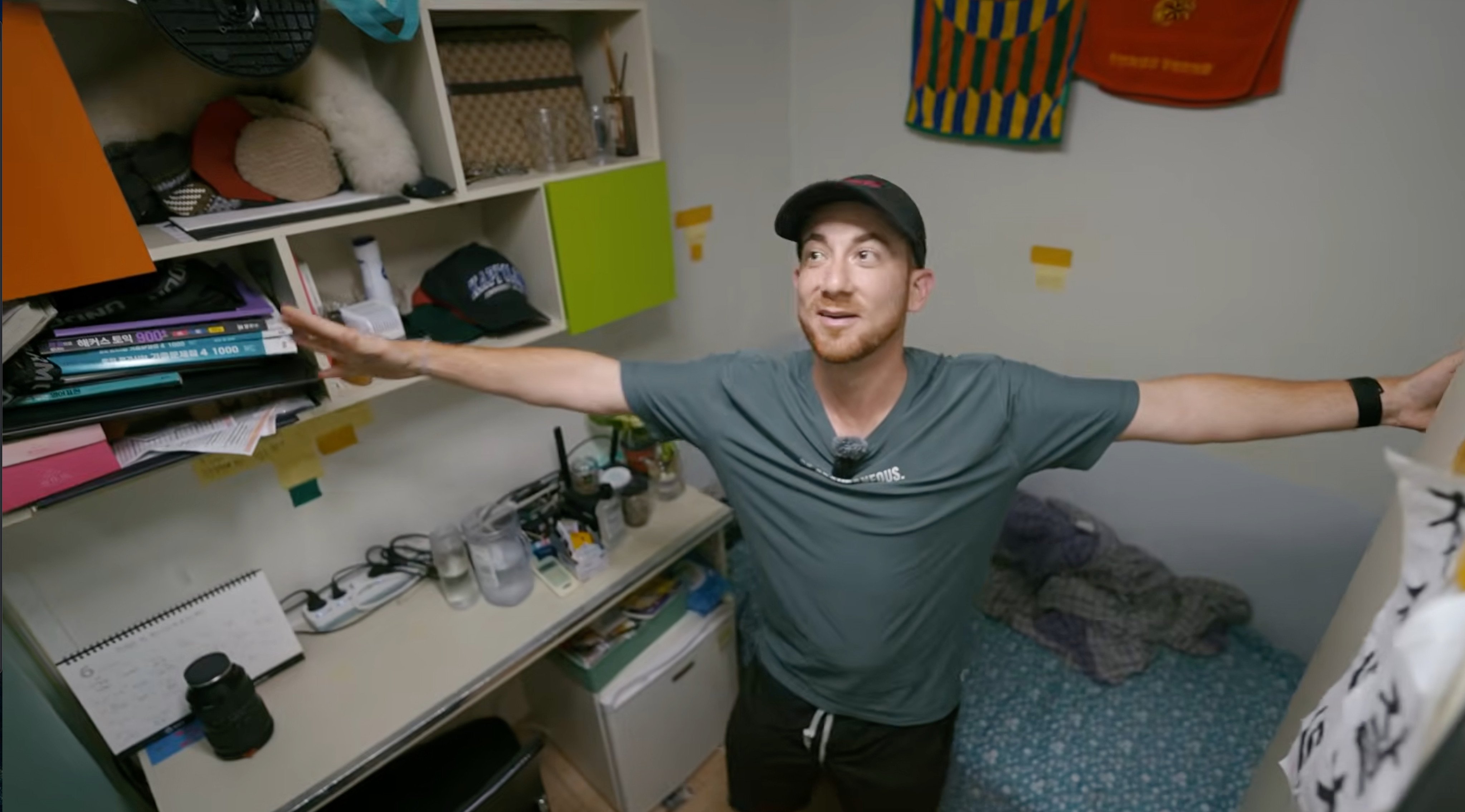 Drew Binsky inside a Seoul gosiwon on February 1, his outstretched arms nearly spanning the narrow room. Photo: YouTube/Drew Binsky